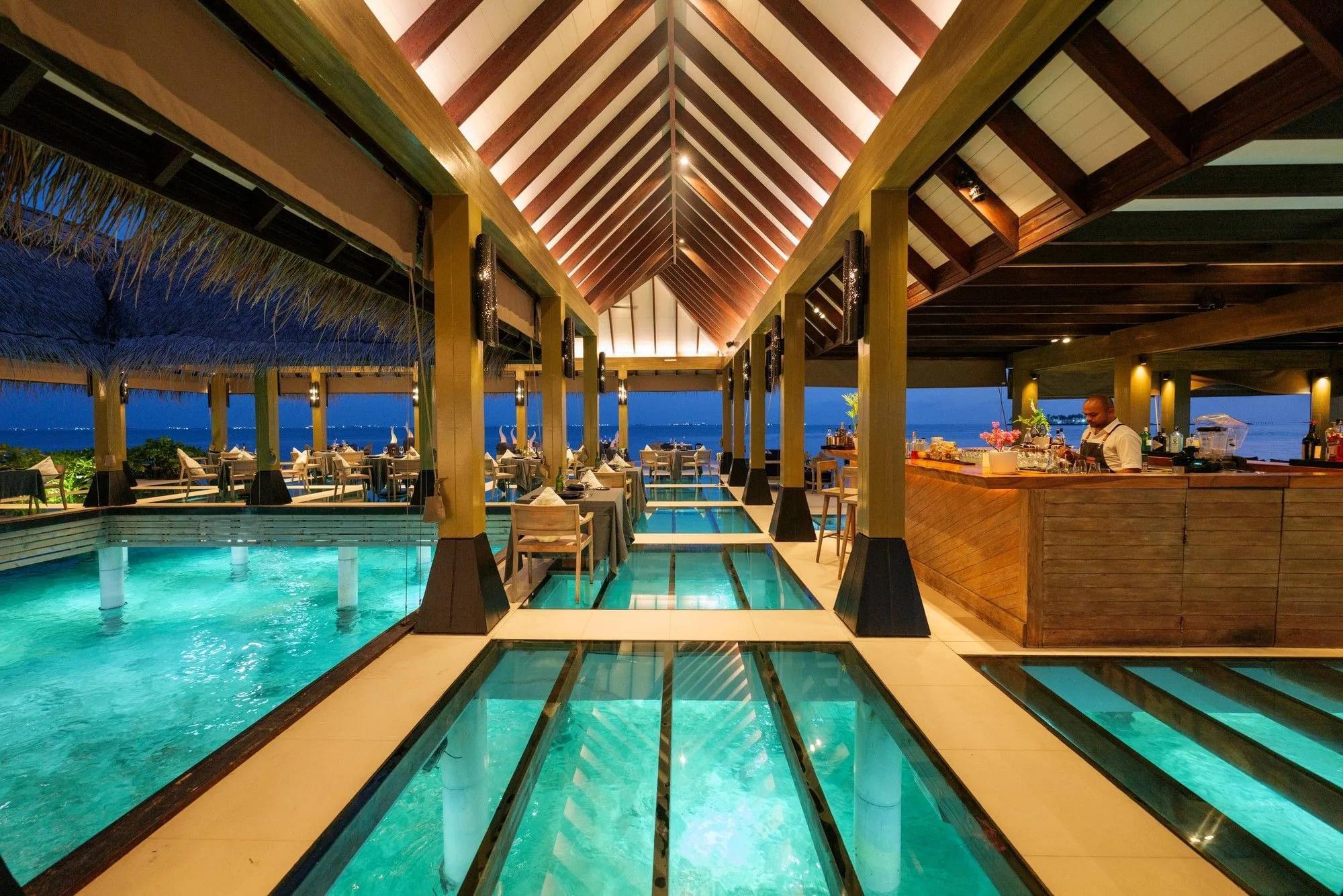 Firedoor, the resort's overwater fine-dining restaurant, reached by a wooden walkway