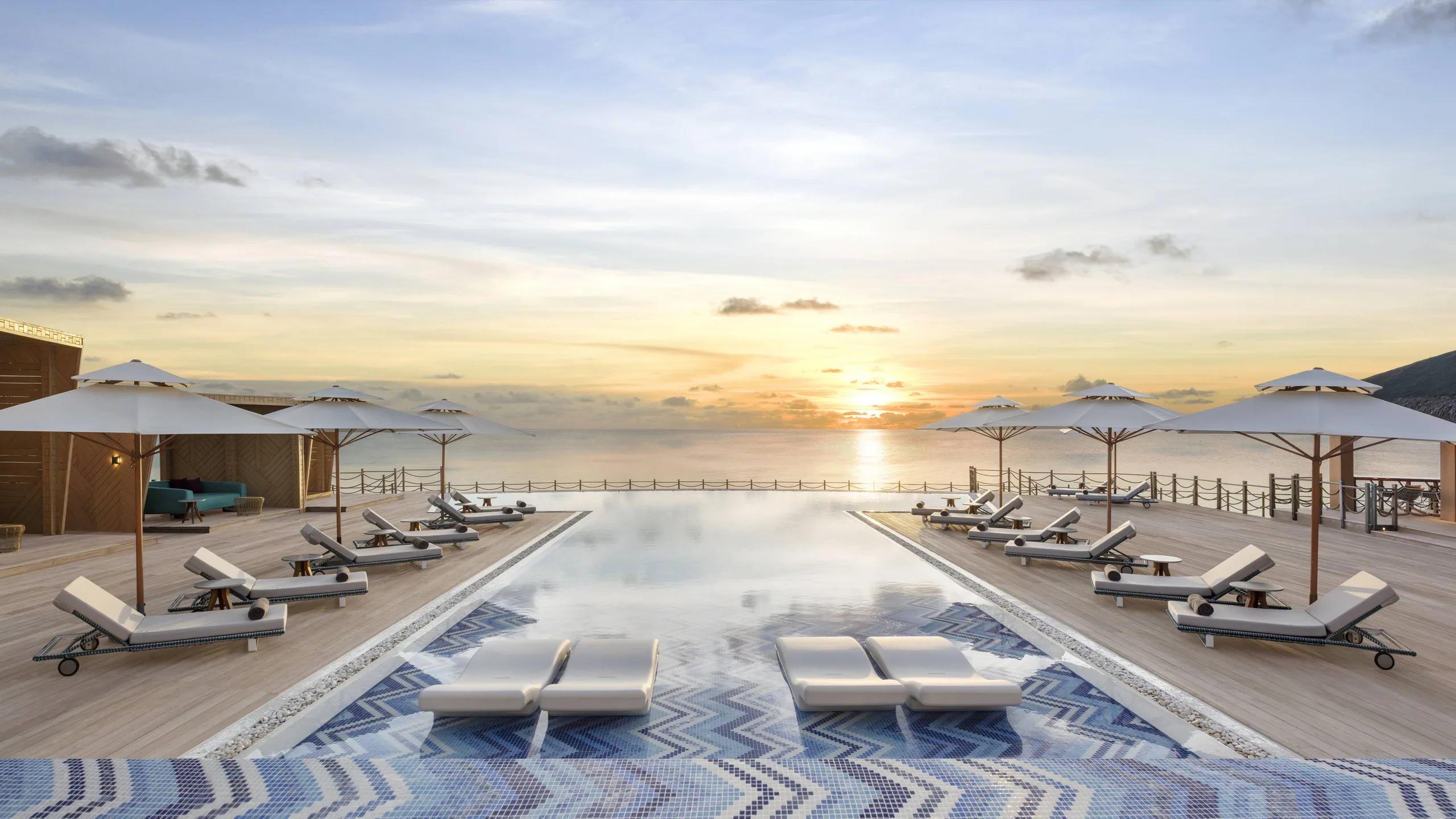 The pool deck at sunset near Fiamma, JW Marriott Maldives's poolside Italian restaurant; a dedicated photograph of Fiamma itself was not available in the resort's research imagery