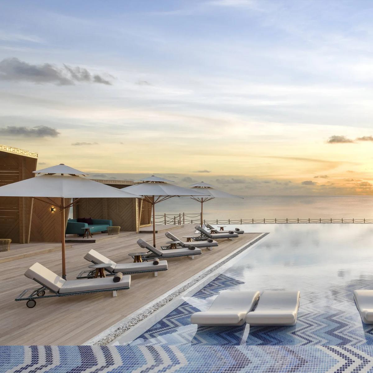 The pool deck at sunset near Fiamma, JW Marriott Maldives's poolside Italian restaurant; a dedicated photograph of Fiamma itself was not available in the resort's research imagery