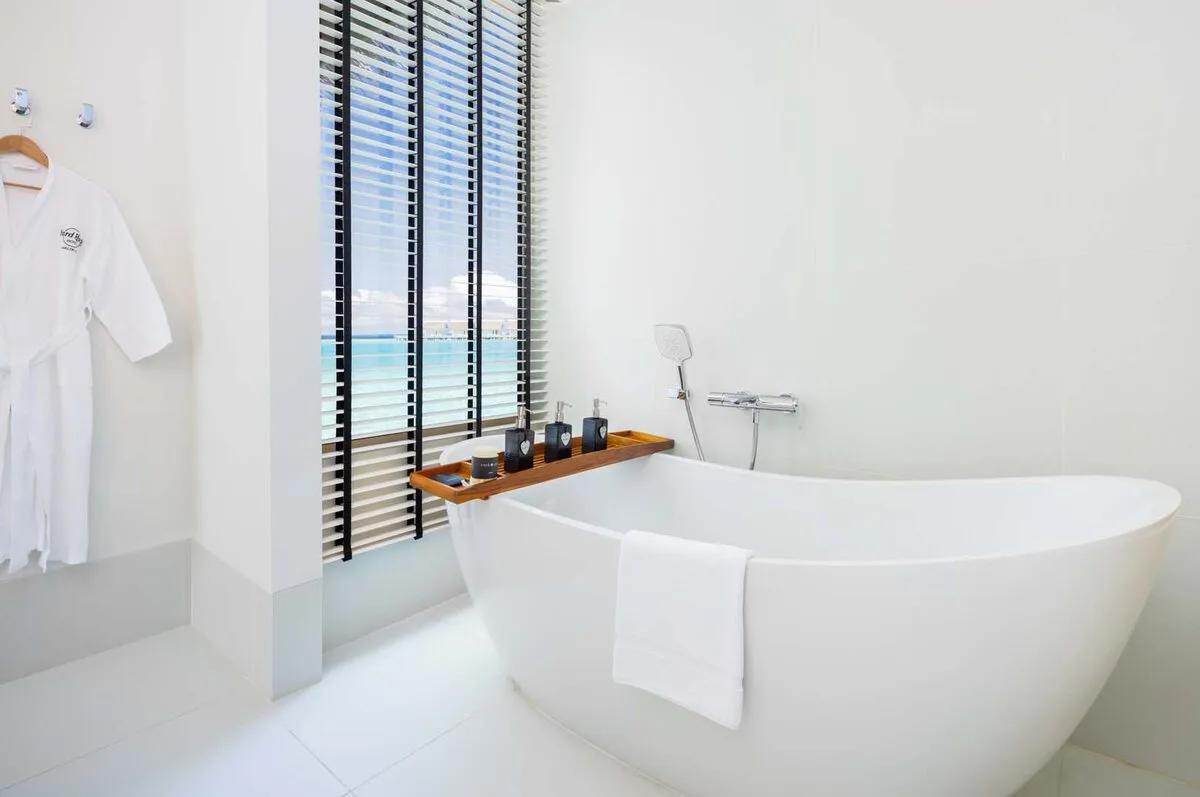 A Platinum-category overwater villa's interior, opening onto the deck above the lagoon