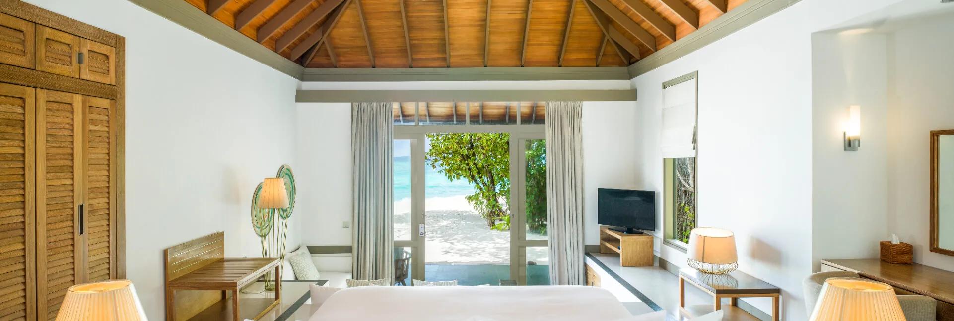 A Beach Villa with Private Pool at JA Manafaru, set in a garden at the water's edge