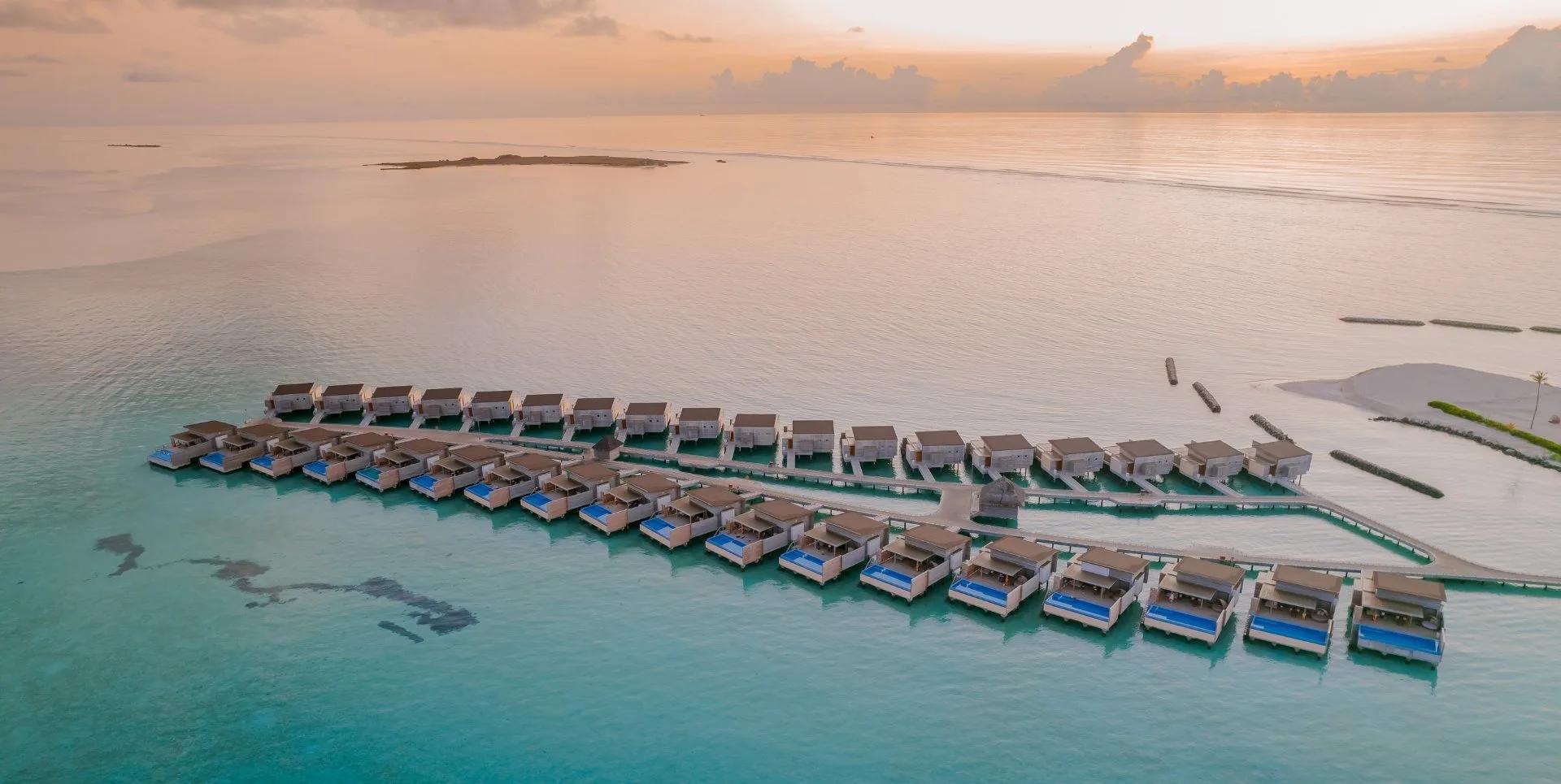 A Sunset Water Villa's private pool and deck, built out over the lagoon