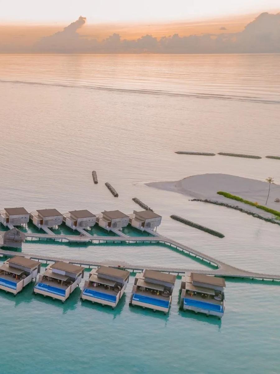 A Sunset Water Villa's private pool and deck, built out over the lagoon