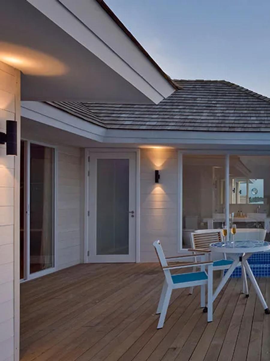 The Sunset Aqua Pool Suite's private infinity pool and deck at sunset, built out over the lagoon