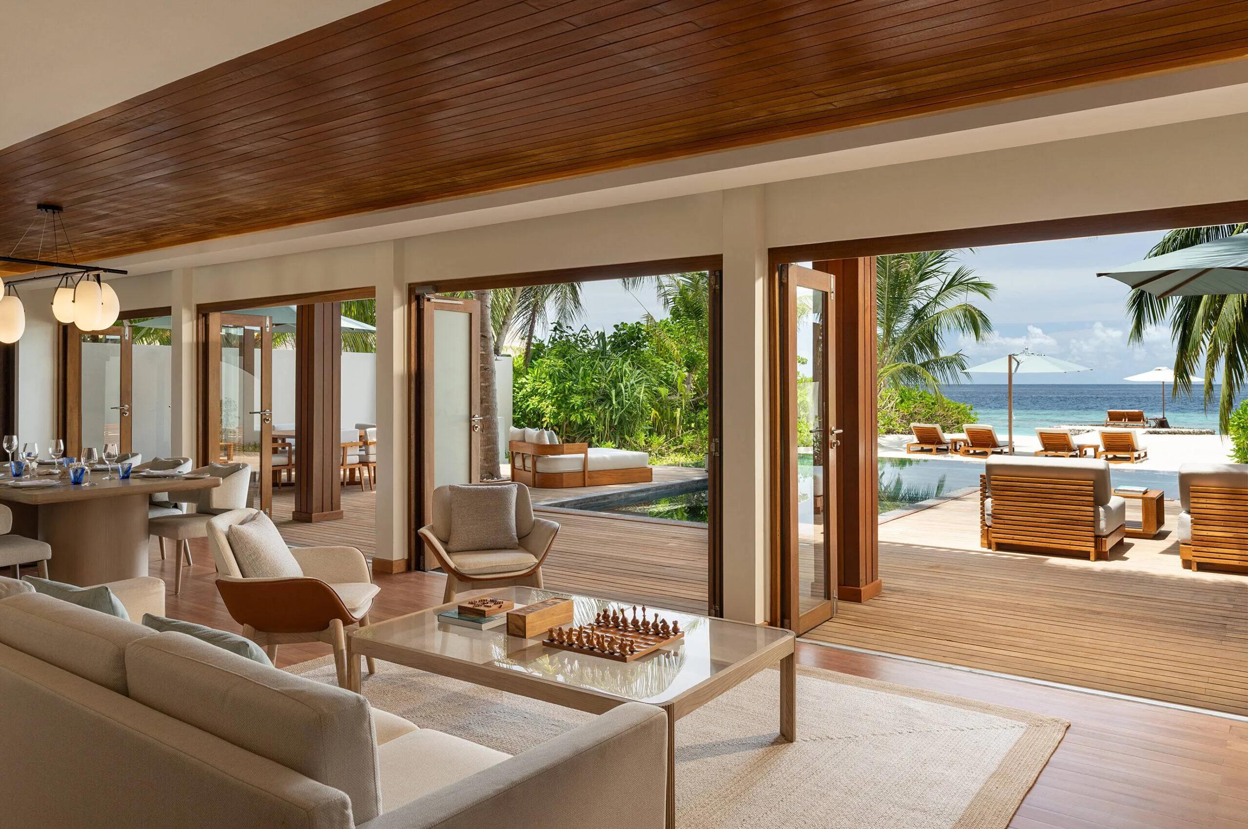 The Two-Bedroom Beach House's living room opening onto its private pool and the beach