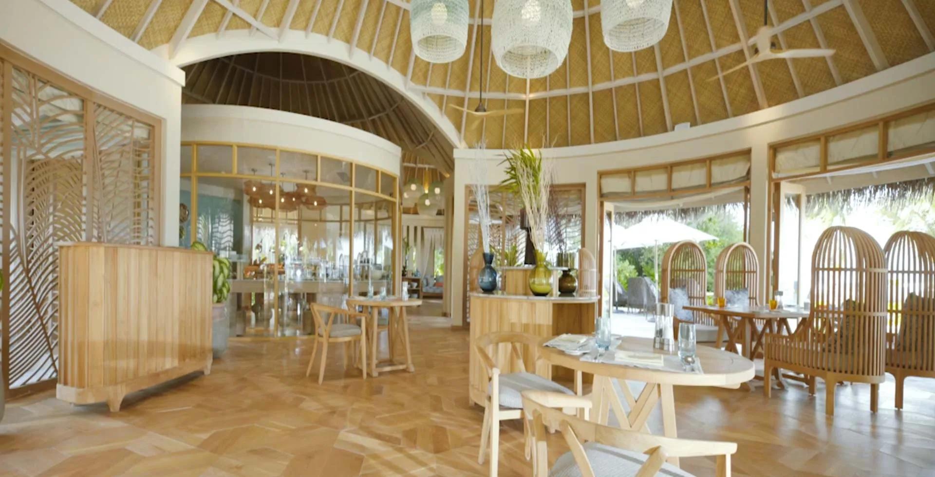 Thyme's domed, thatched-roof dining room, tables set beneath woven pendant lights.