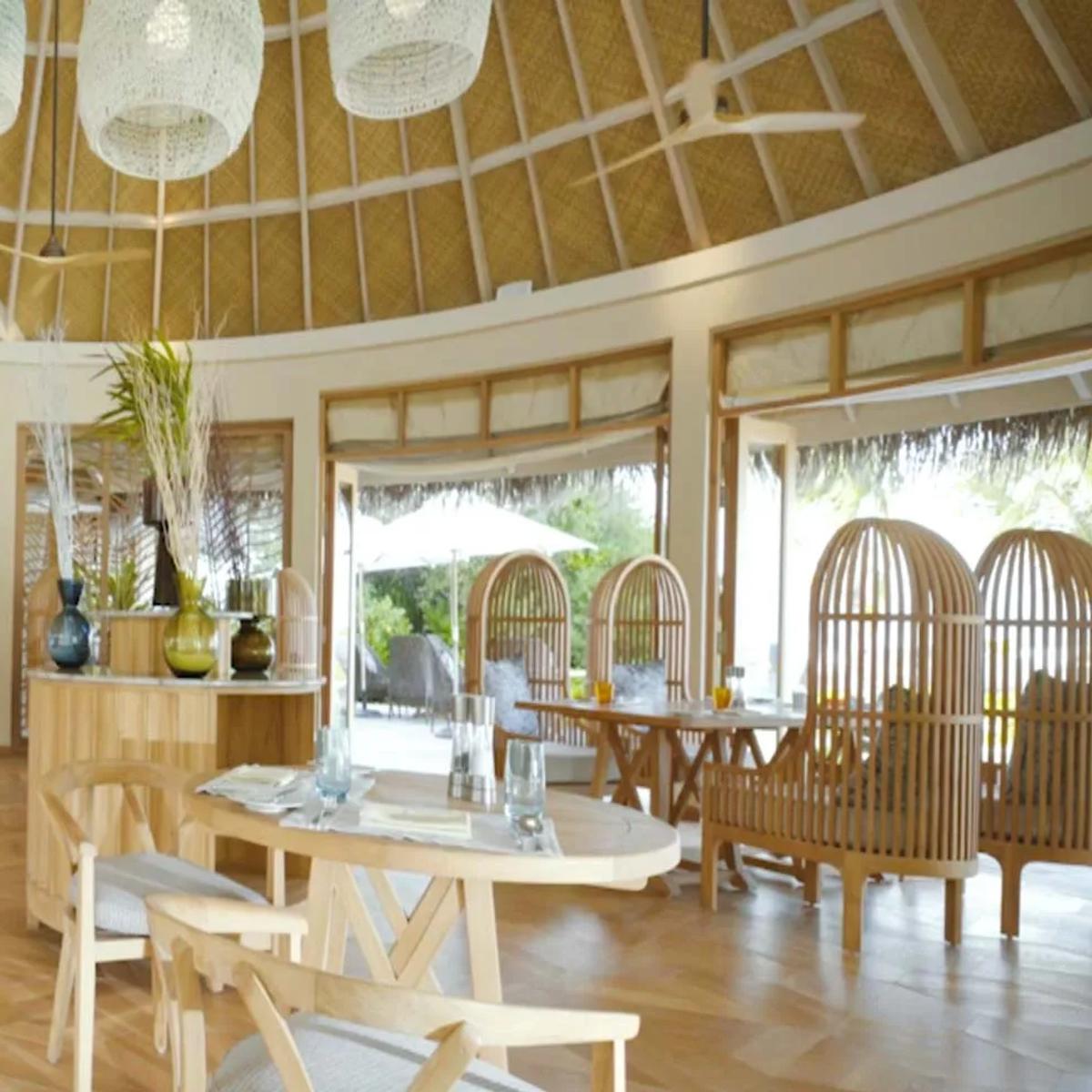 Thyme's domed, thatched-roof dining room, tables set beneath woven pendant lights.