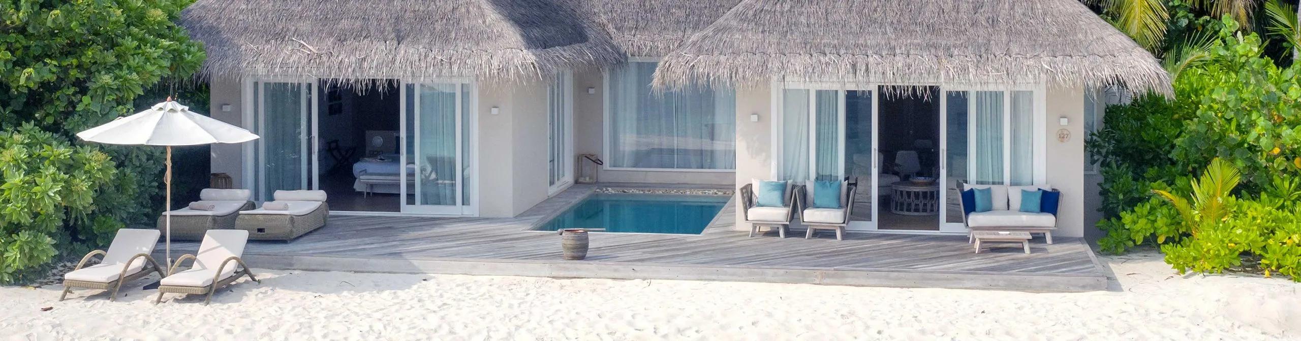 A Deluxe Beach Suite with Pool's twin thatched pavilions set either side of a private plunge pool, beachfront at Baglioni Maldives