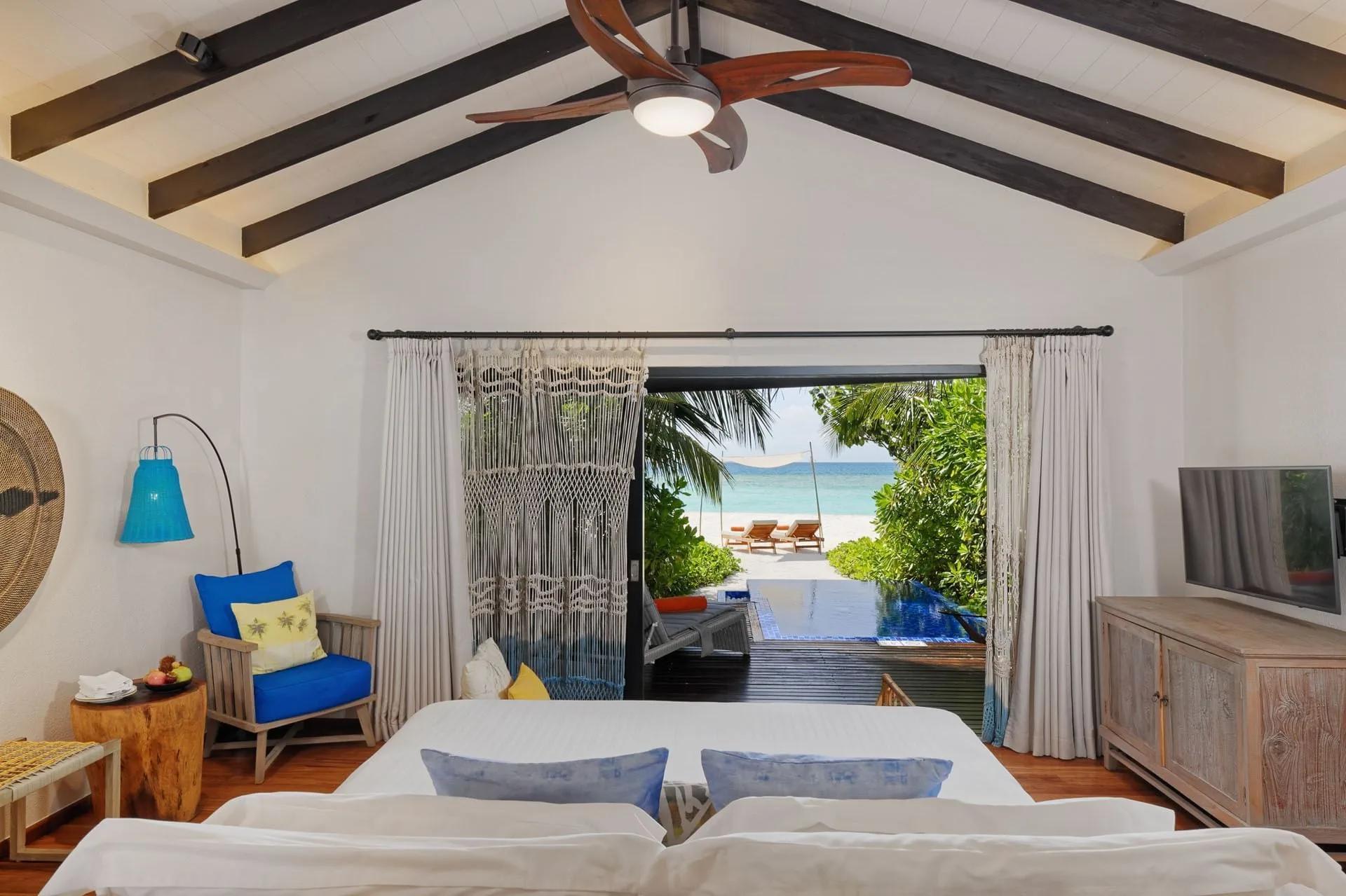 The bedroom of a Beach Pool Villa, overlooking its private pool