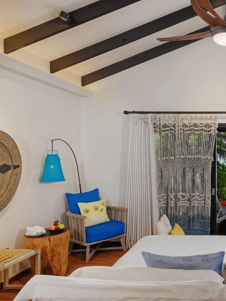 The bedroom of a Beach Pool Villa, overlooking its private pool