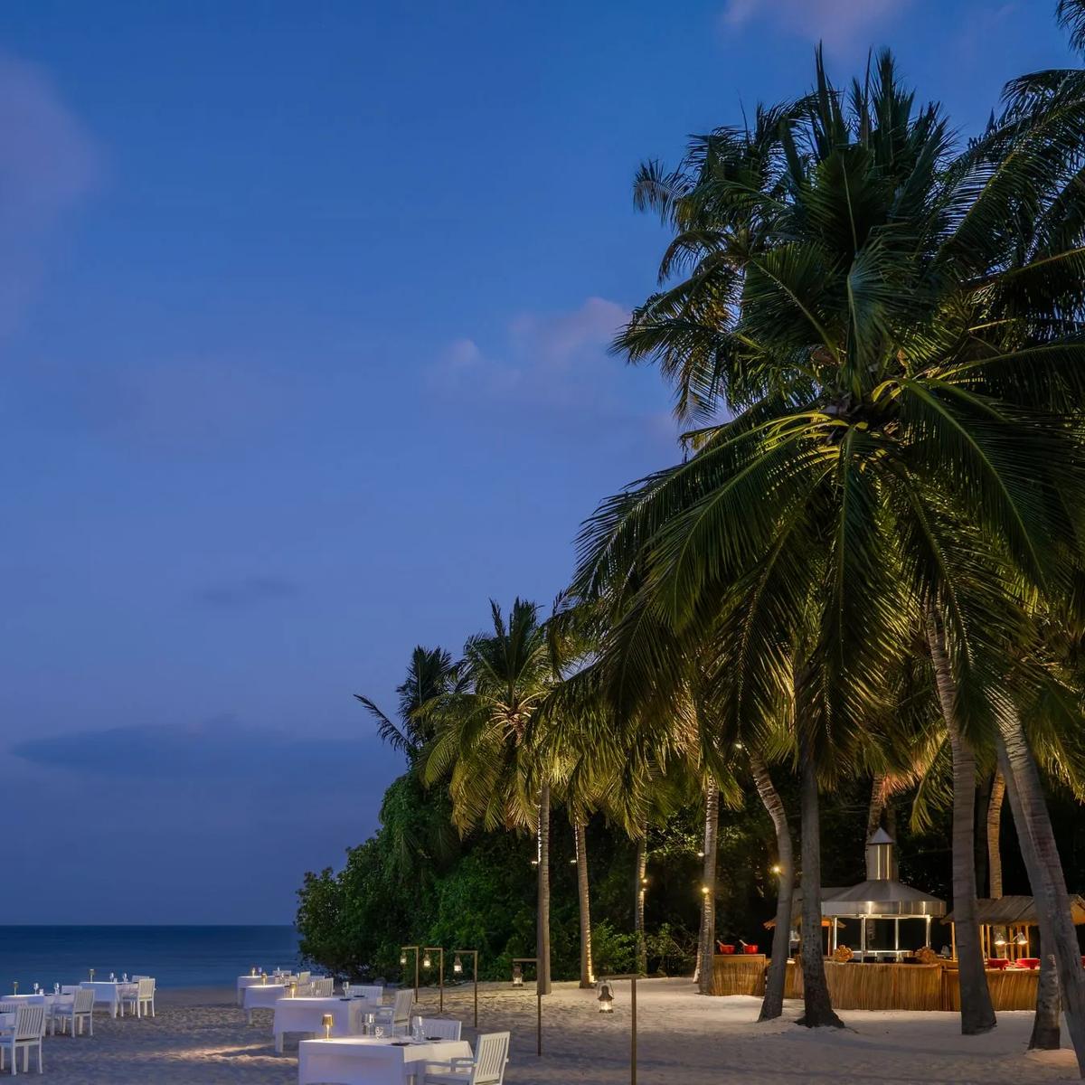 Torch-lit tables at The Firepit, Halcyon's open-flame beach grill
