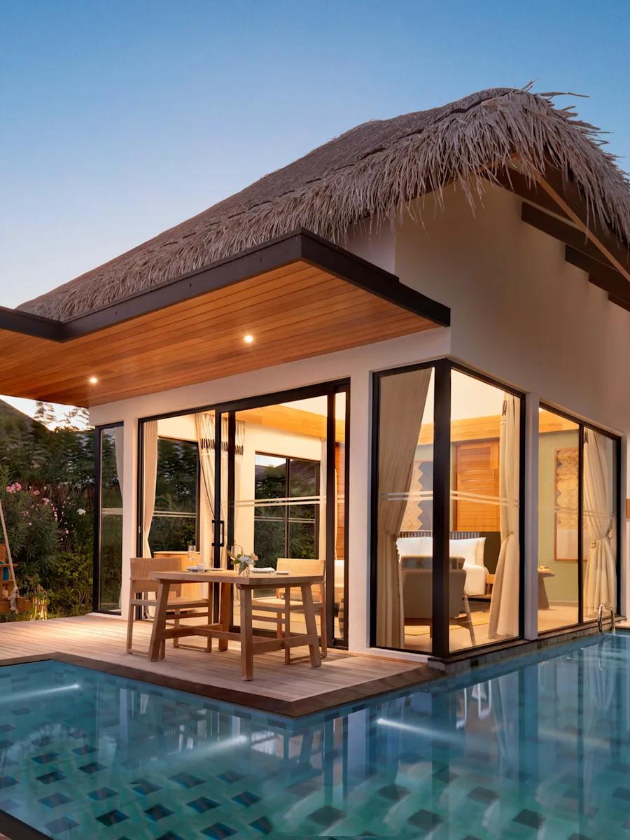 The exterior of a One Bedroom Beach Pool Villa, set among palms with its own private pool