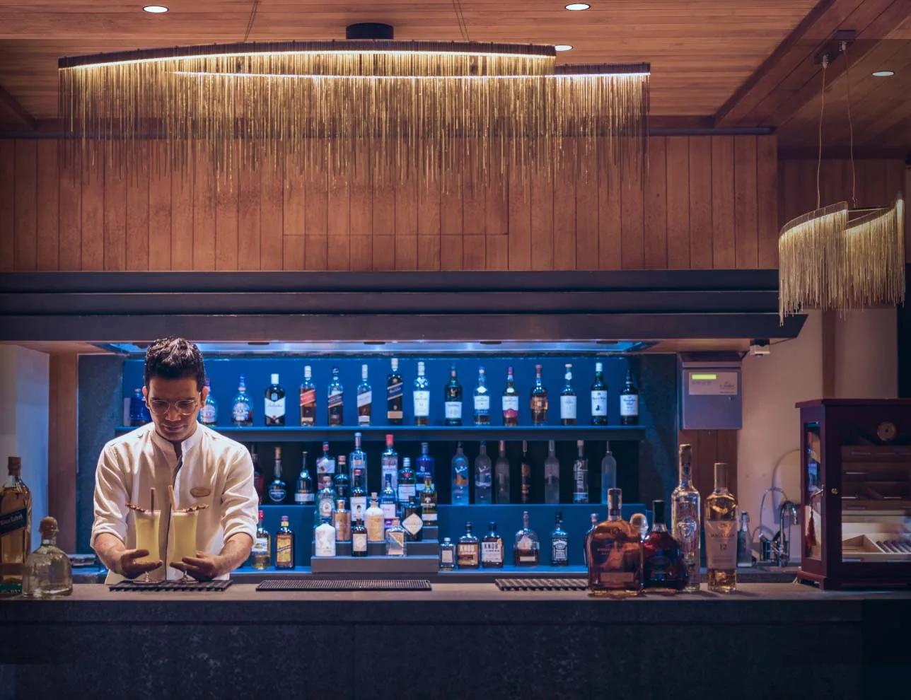 A bartender preparing cocktails at Baa Bar, Amilla; a dedicated photograph of Sunset Bar was not available in this research pool