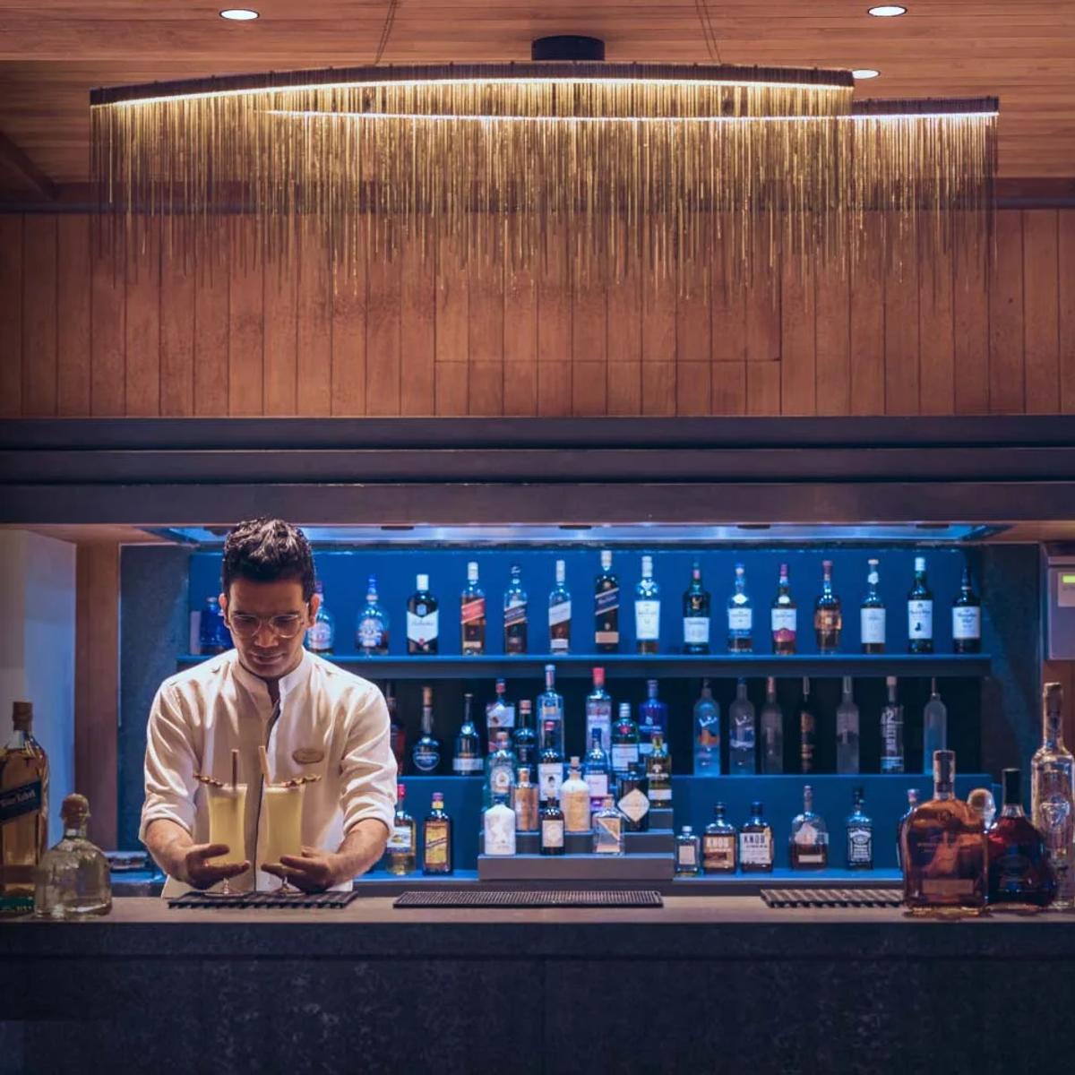 A bartender preparing cocktails at Baa Bar, Amilla; a dedicated photograph of Sunset Bar was not available in this research pool