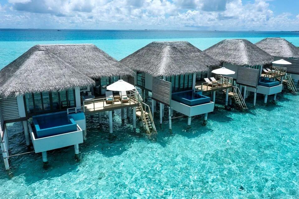A row of Water Villas with Pool stepping out over the lagoon, each with its own plunge pool
