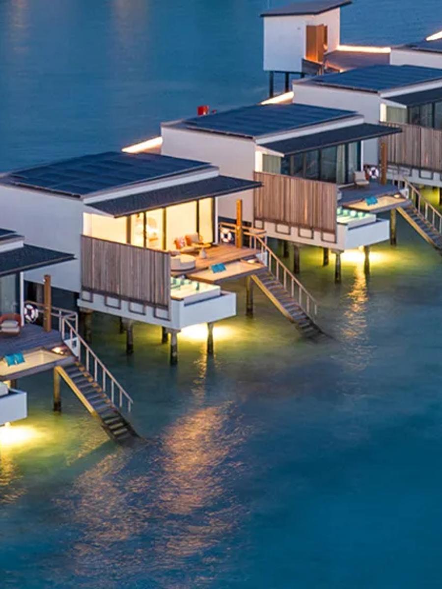 Overwater villas at SO/ Maldives lit at dusk, each with its own private pool on the deck — representative of the Water Pool Villa category; a dedicated photograph was not available