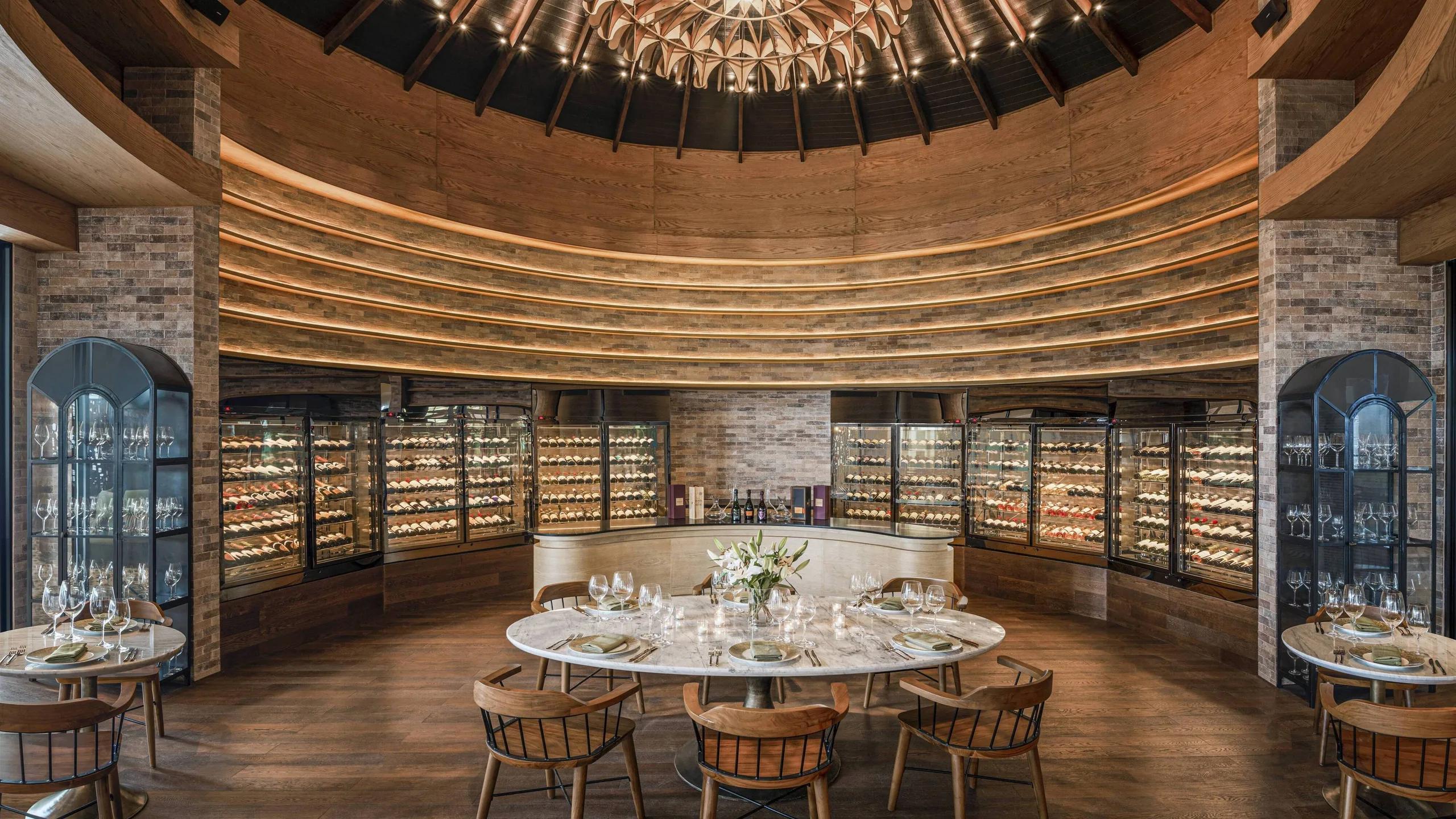 The Wine Room, its curved wall of glass-fronted cellars encircling a central tasting table