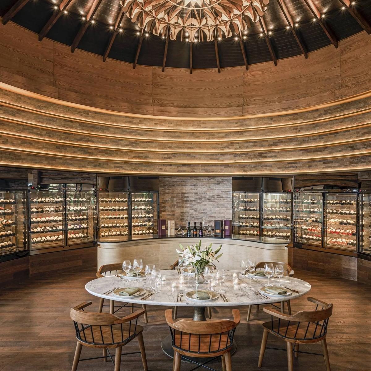 The Wine Room, its curved wall of glass-fronted cellars encircling a central tasting table