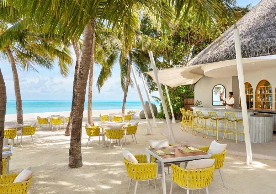 Tables at Dune, Niyama's beach café under the coconut palms