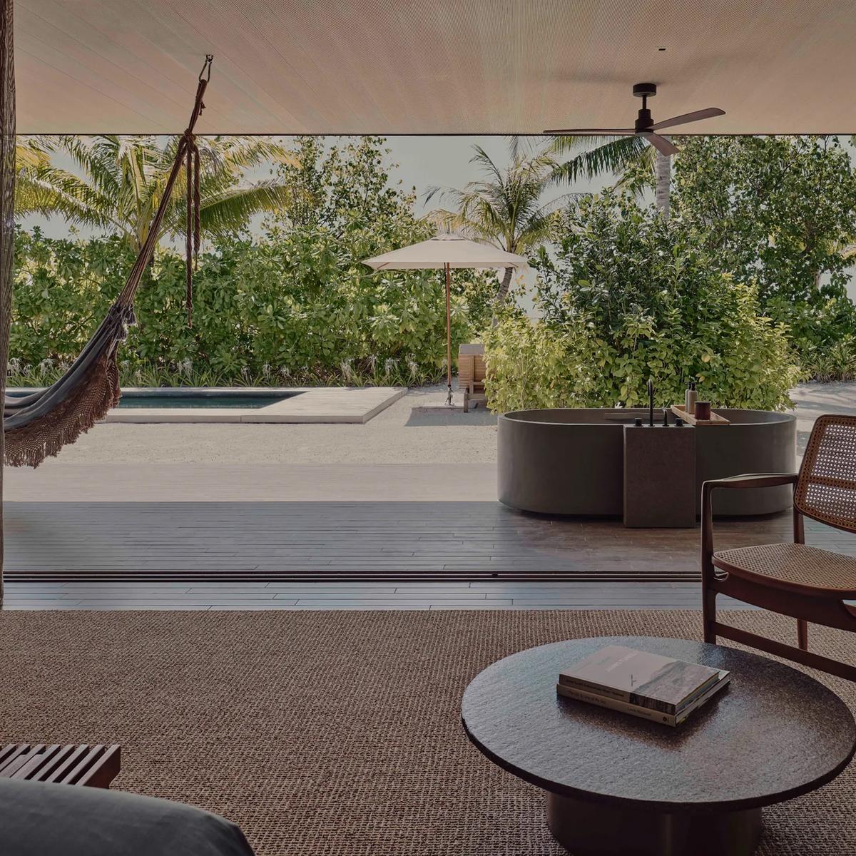 A garden terrace at Patina Maldives, dense tropical planting around a private pool; a dedicated photograph of Organic Garden, the resort's garden dining venue, to follow