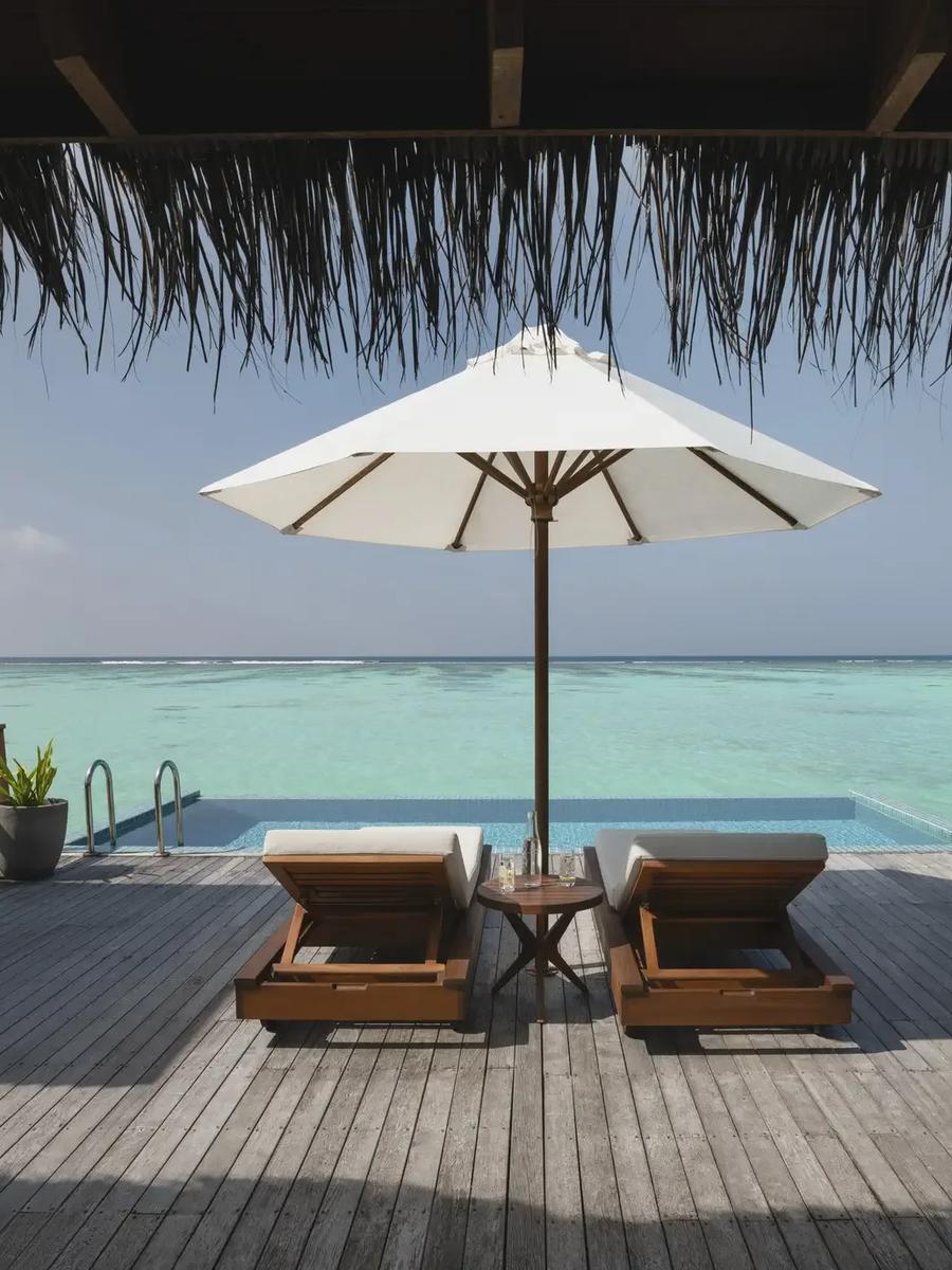 The infinity-edge pool and deck of a Premier Water Villa with Pool at Conrad Maldives Rangali