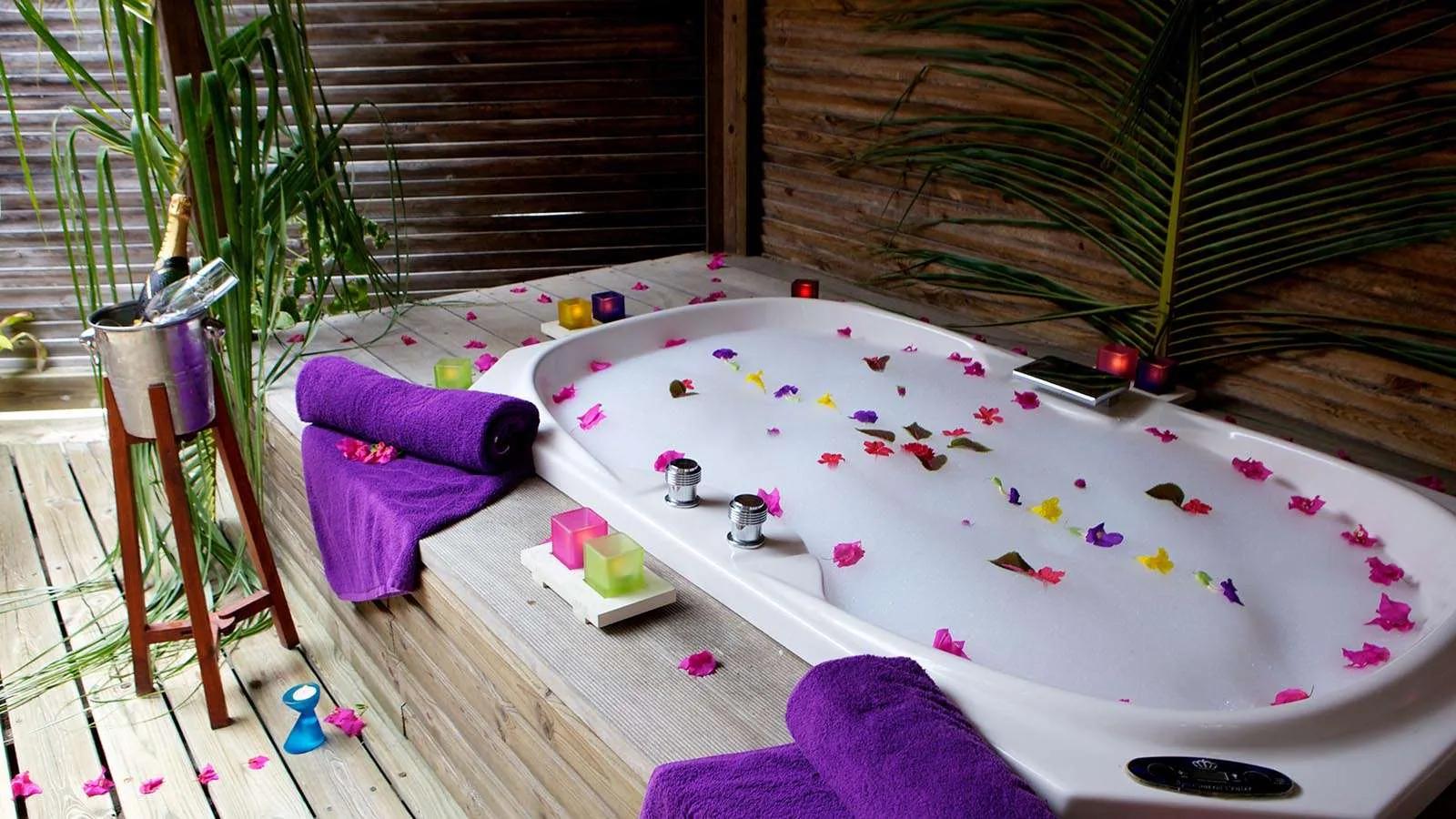 Sangu Jacuzzi Beach Villa exterior, a blue-grey wood villa set back from the beach under palms