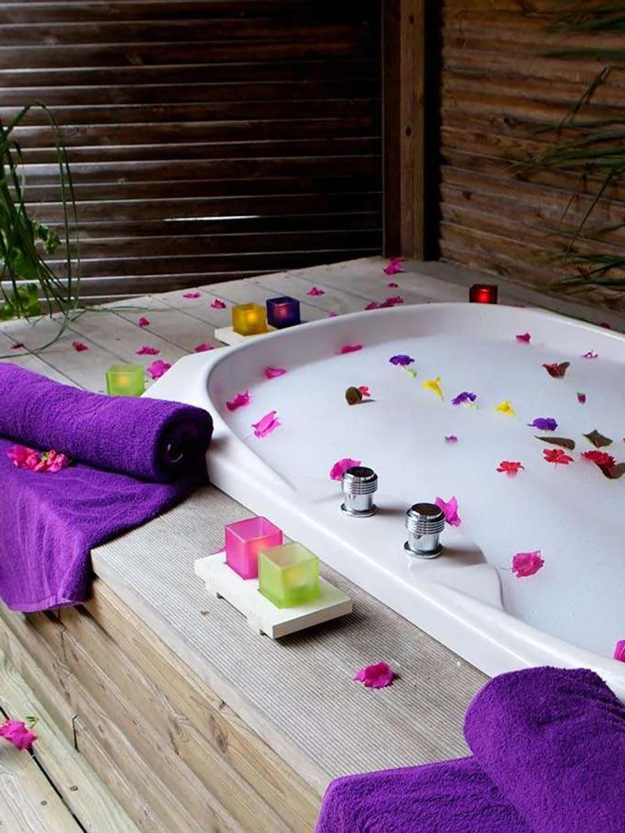 Sangu Jacuzzi Beach Villa exterior, a blue-grey wood villa set back from the beach under palms