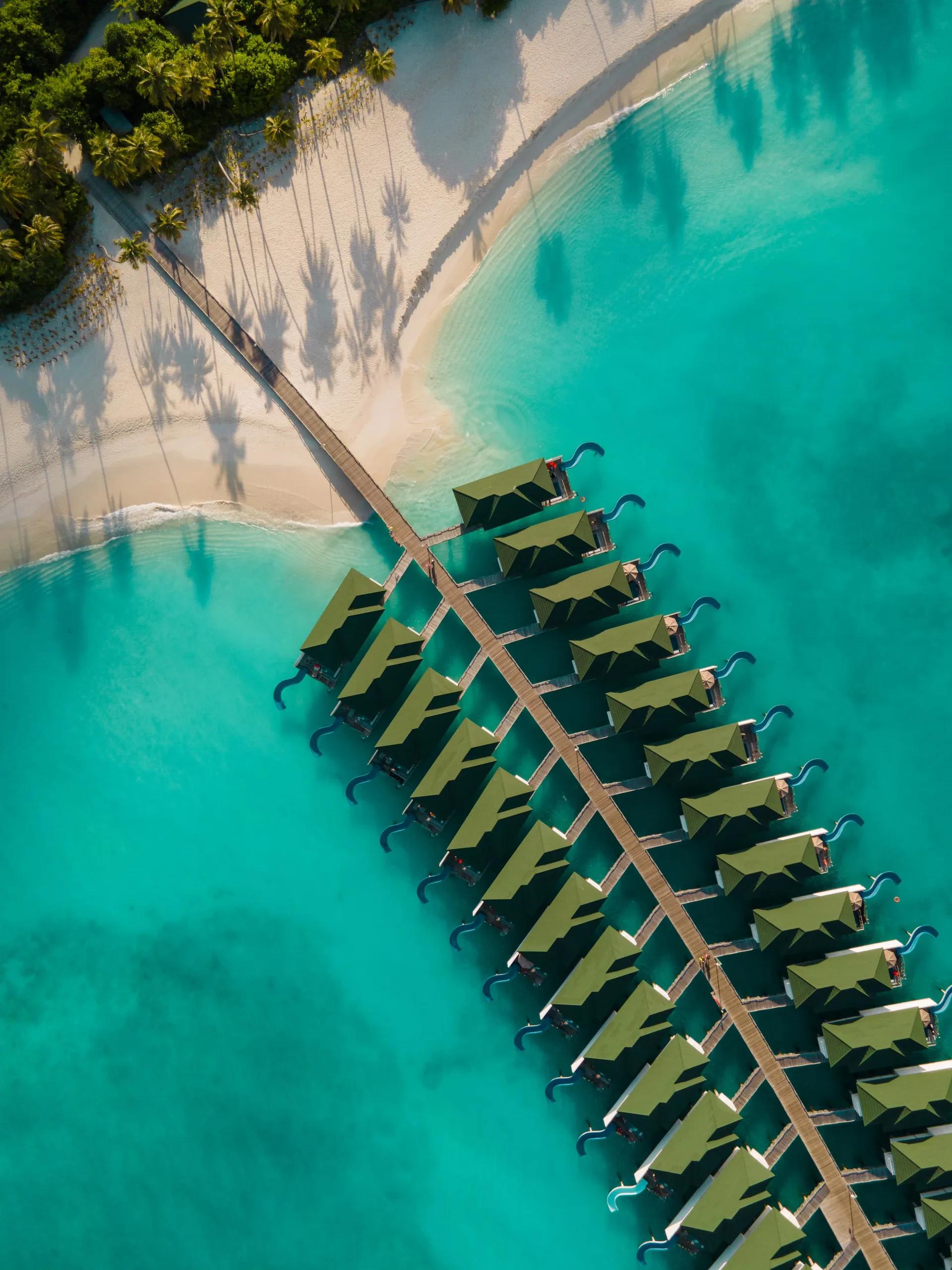Siyam World's island seen directly from above, villas ringing the shoreline