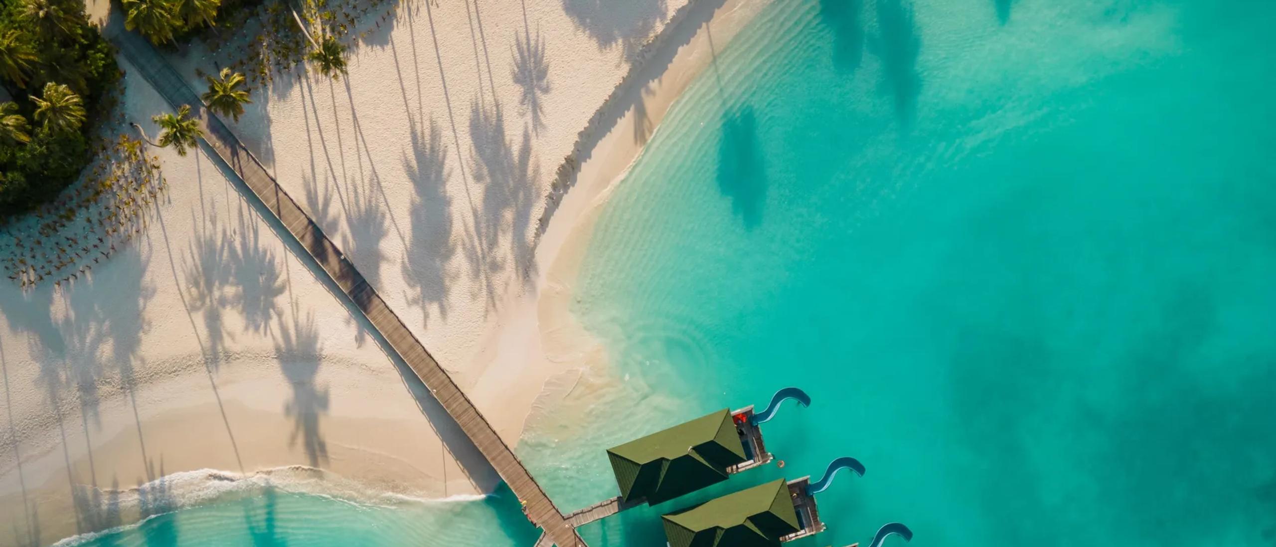 Siyam World's island seen directly from above, villas ringing the shoreline