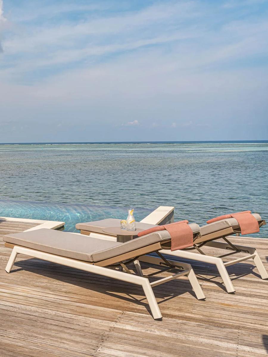 The Sunrise Family Water Villa's overwater deck and infinity-edge pool