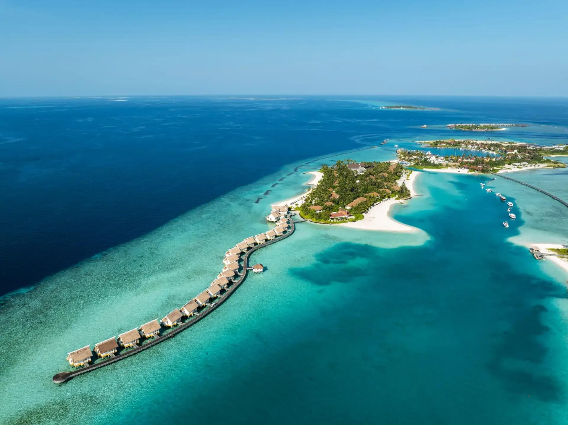 Wide aerial view of SAii Lagoon Maldives and its boardwalk-linked island group