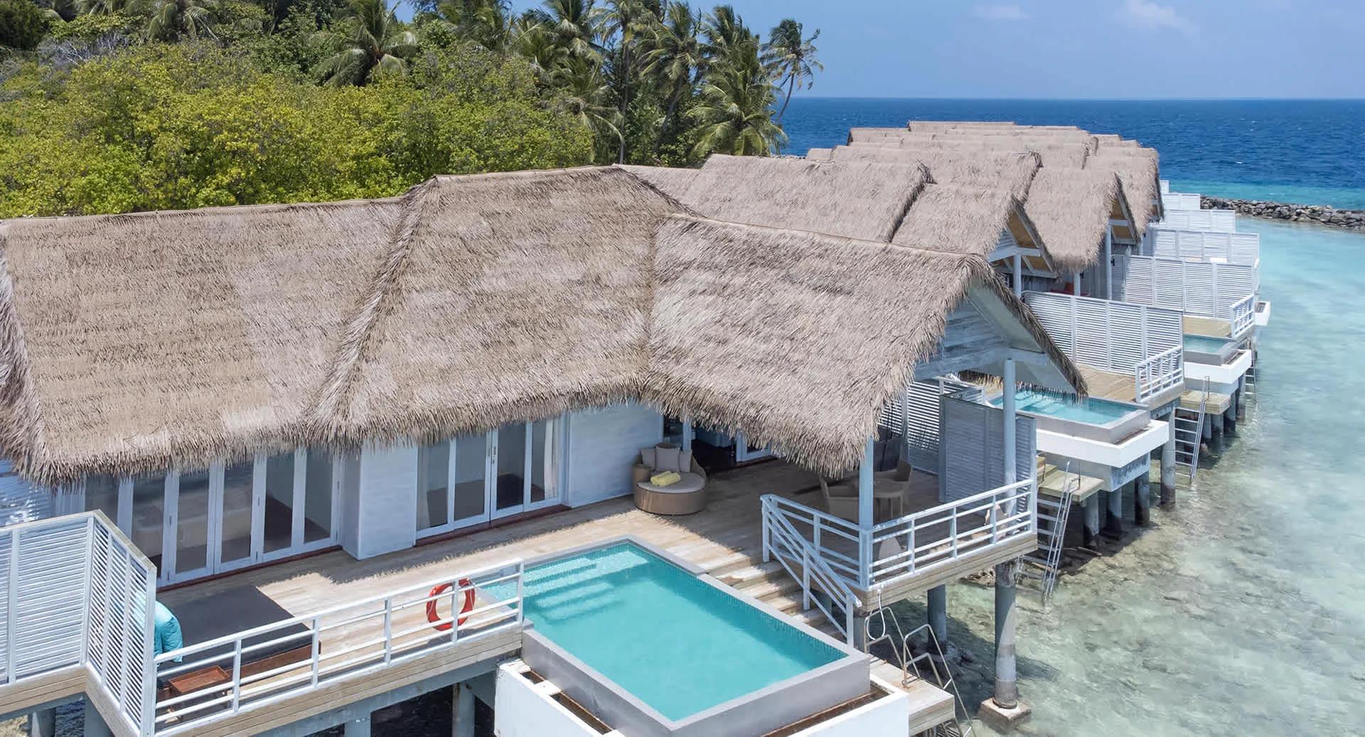 The row of Over Water Suites with Private Pool, thatched roofs stepping out over the lagoon