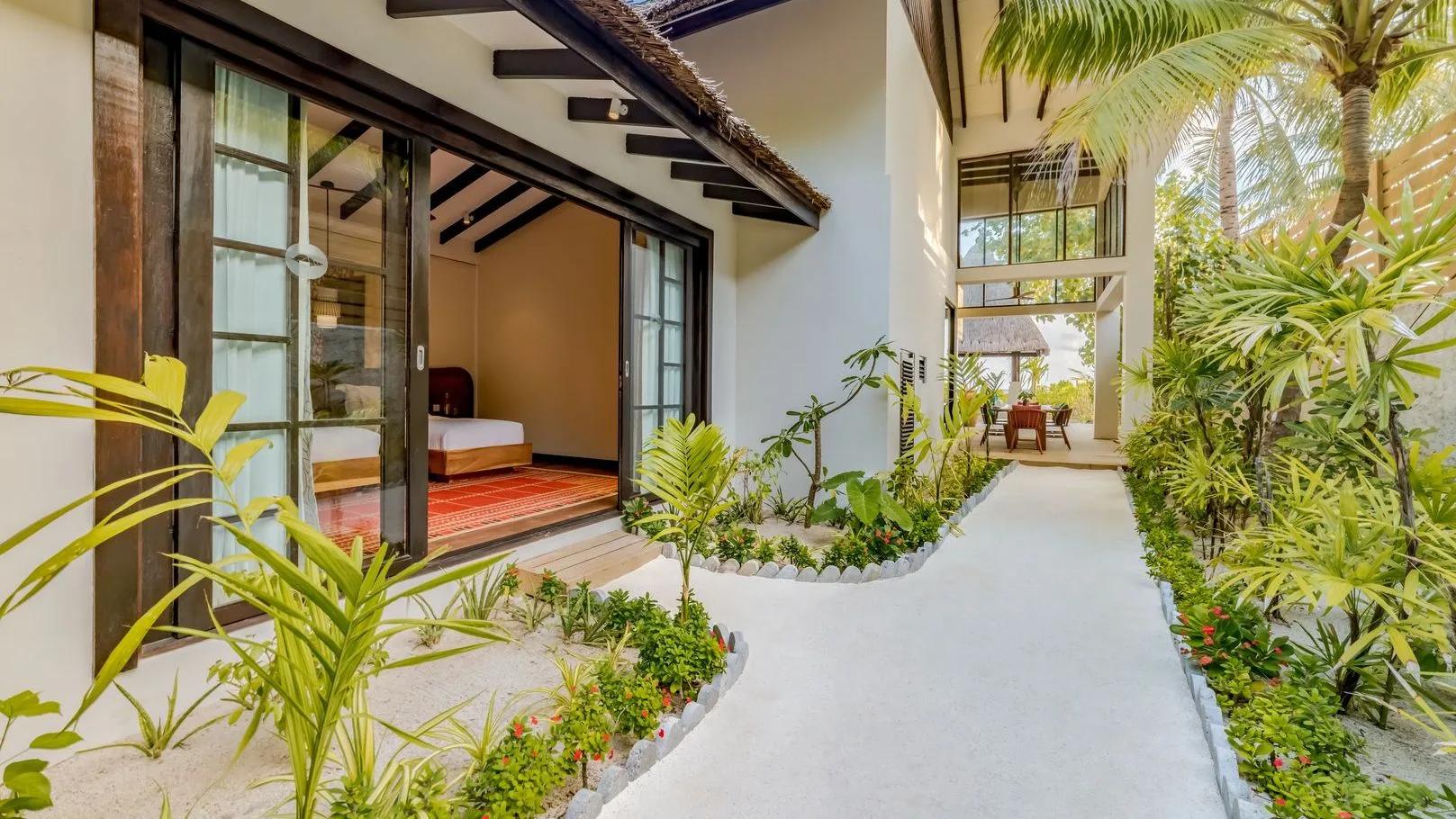 The balcony of an Earth Pool RESERVE Sunset 3BR villa's upper floor, overlooking palm trees toward the beach