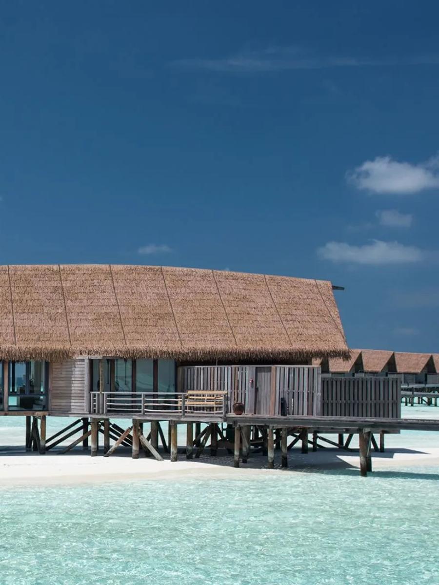A One-Bedroom Water Villa with Pool, its private plunge pool and shaded deck set over the open lagoon