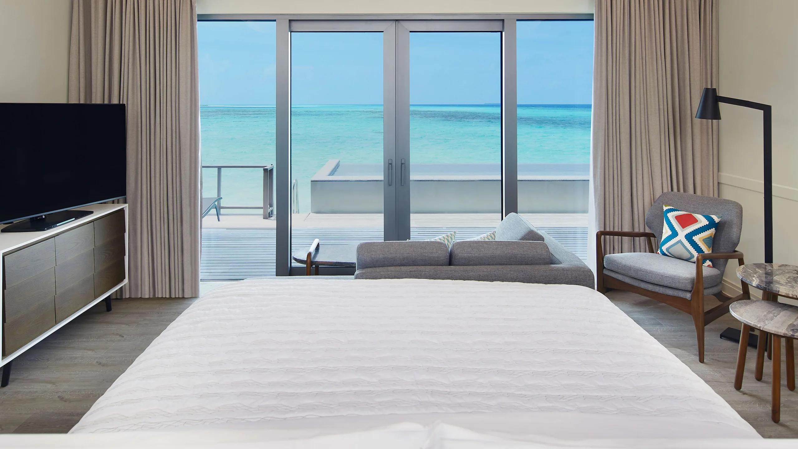 Floor-to-ceiling windows in a Two Bedroom Overwater Pool Villa, looking out over the lagoon