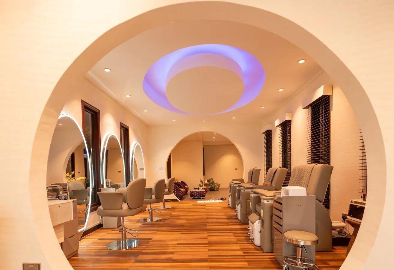 The circular hair and pedicure salon at Essens Wellness and Spa, lit by a blue ring ceiling feature