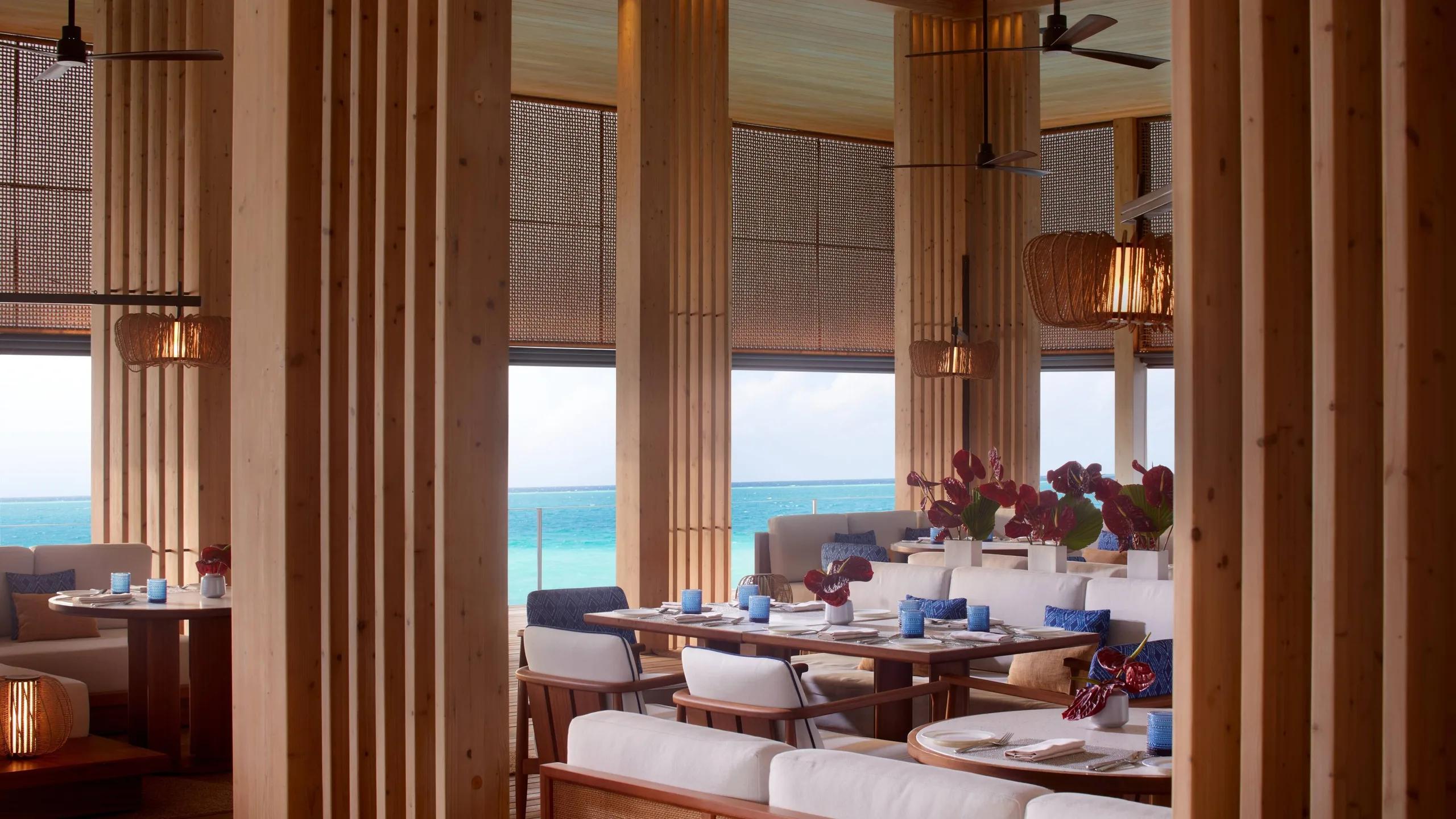 La Locanda's overwater dining room, wood columns framing the lagoon