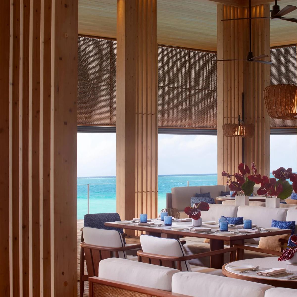 La Locanda's overwater dining room, wood columns framing the lagoon