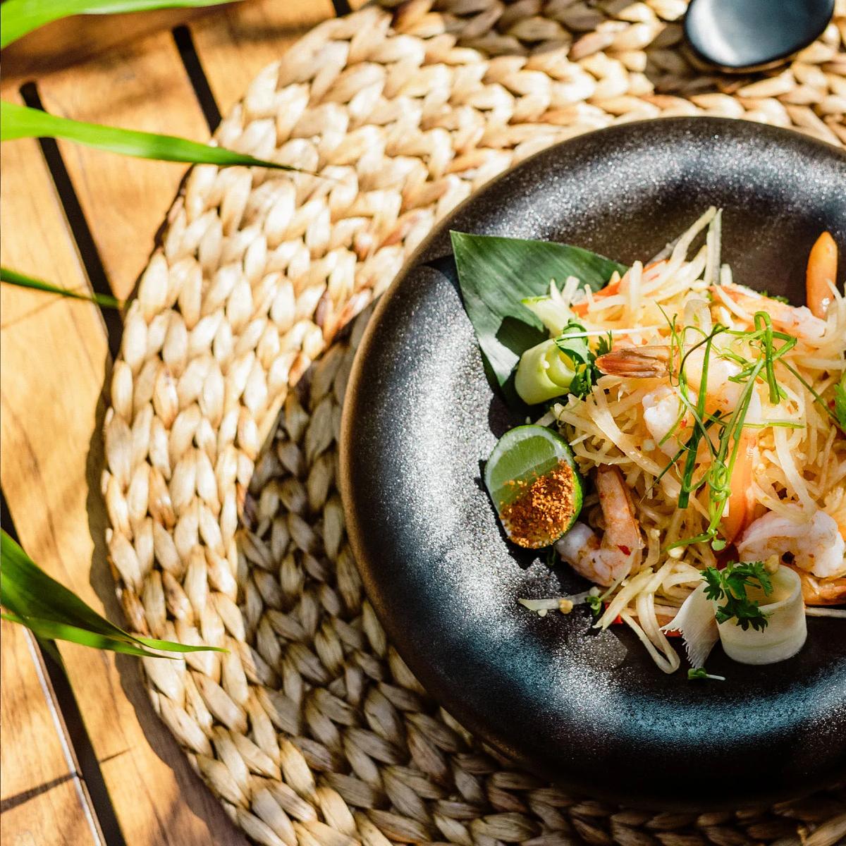 A shrimp and green papaya salad plated with chilli and herbs, served at Bamboo restaurant