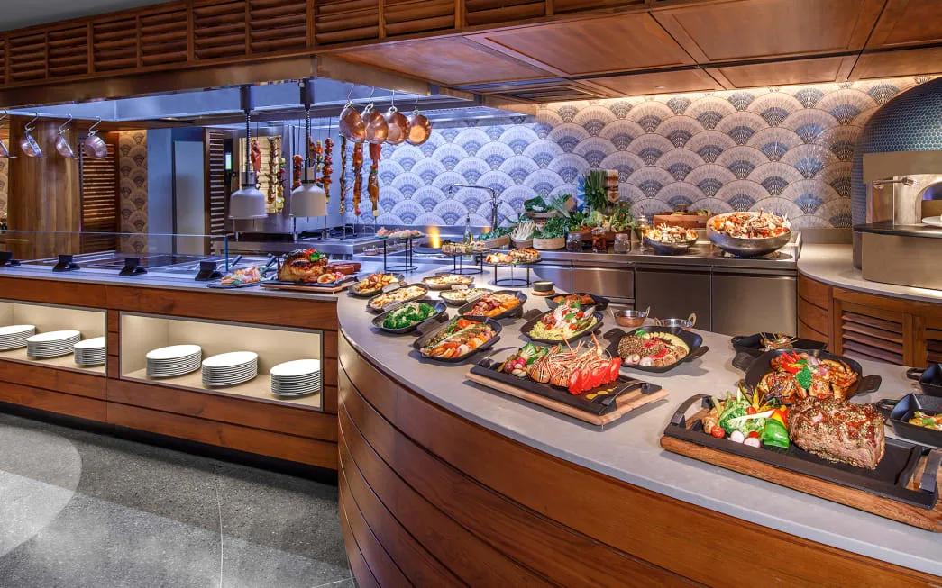 A dinner buffet spread at Fushi Café with grilled meats, salads and seafood