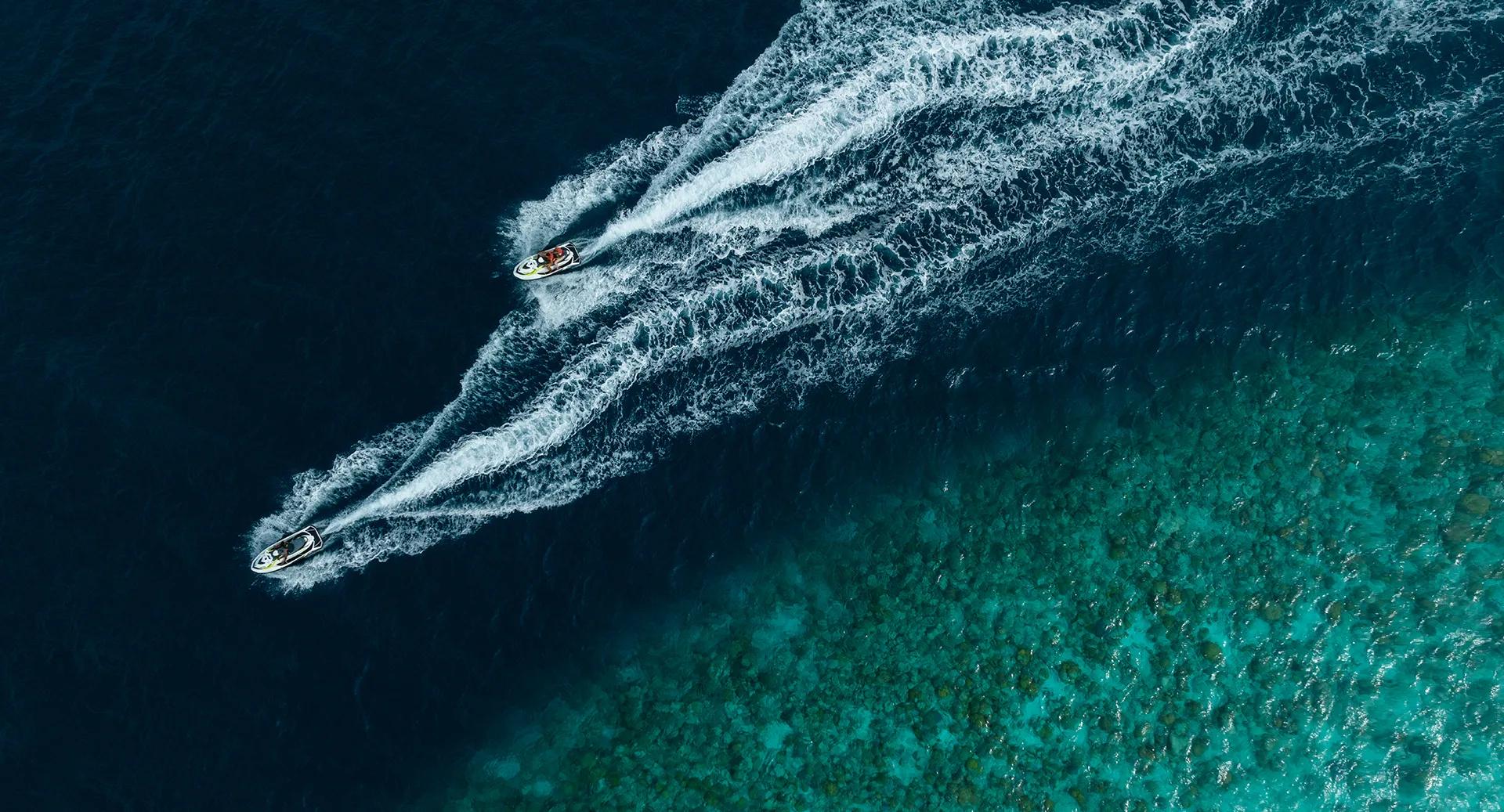A guest riding a jet ski off Avani+ Fares Maldives Resort