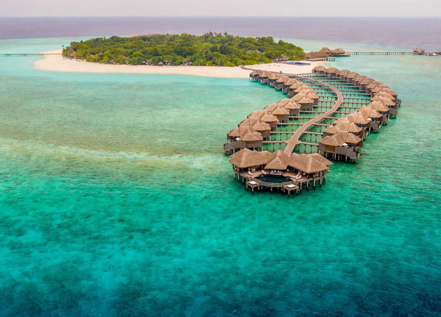 Aerial view of JA Manafaru's twin overwater villa jetties reaching into the Haa Alifu Atoll lagoon