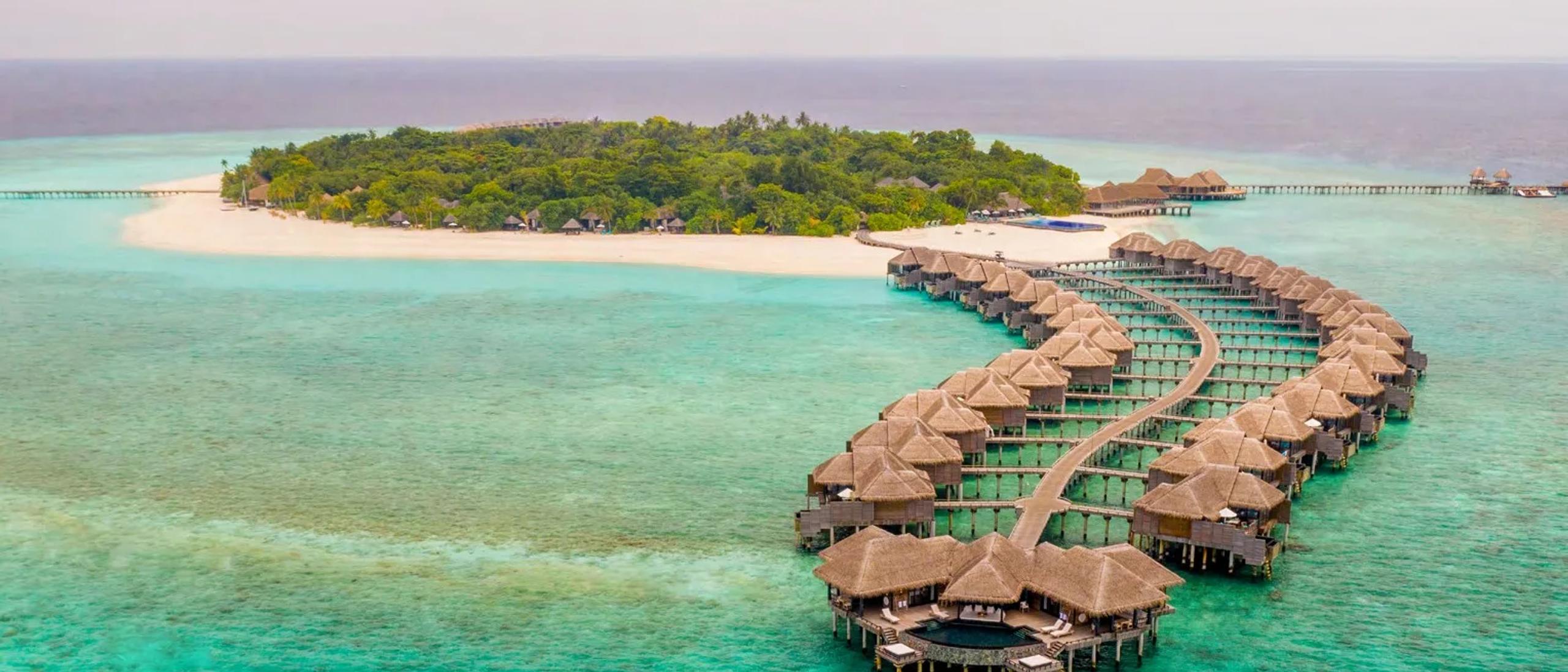 Aerial view of JA Manafaru's twin overwater villa jetties reaching into the Haa Alifu Atoll lagoon