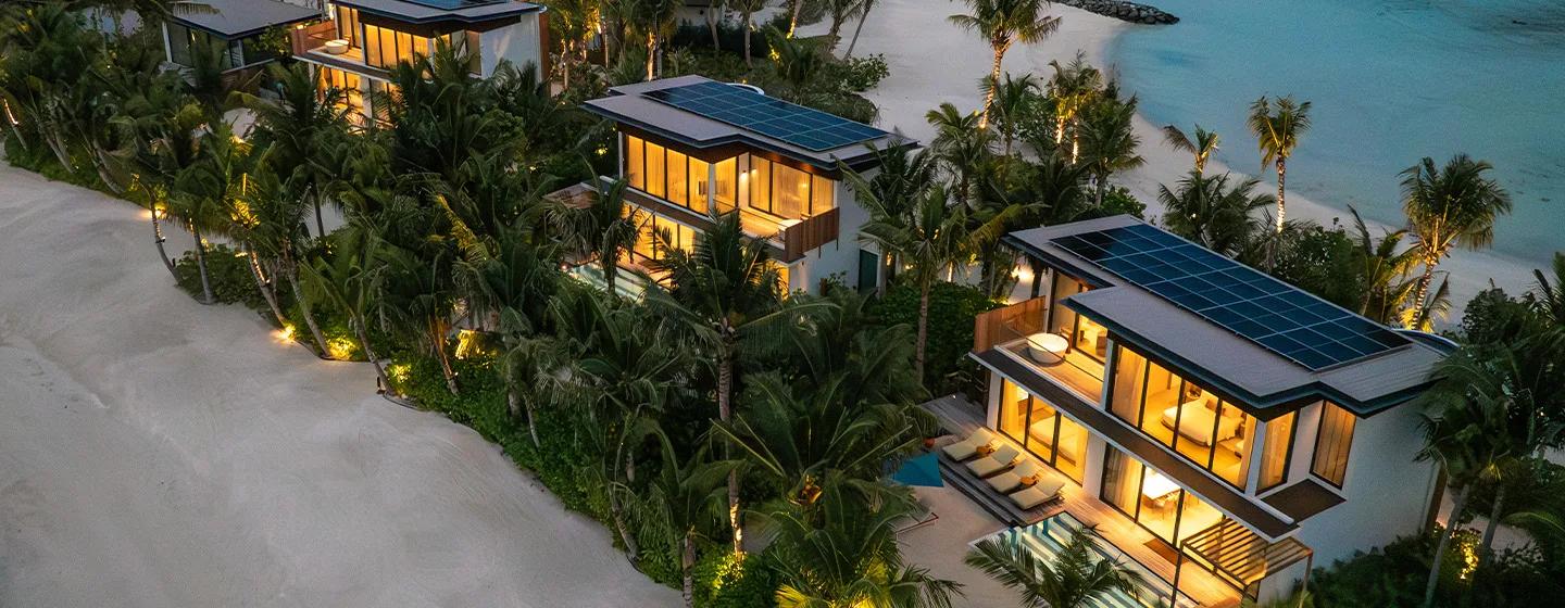 Two-storey beach villas at SO/ Maldives lit at dusk, their upper floors and private pools visible among the palms — representative of the Two-Bedroom Lagoon Beach Pool Loft; a dedicated photograph was not available