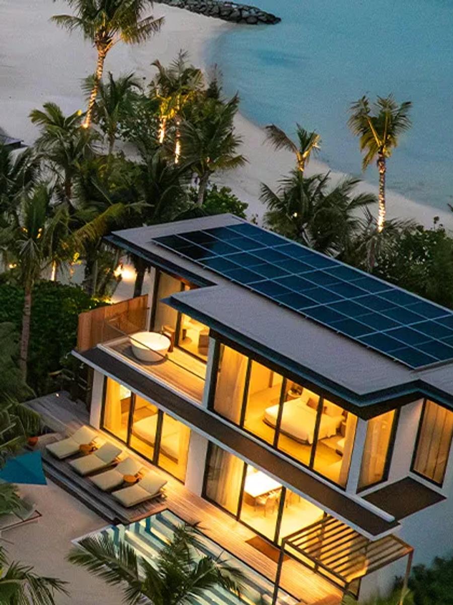 Two-storey beach villas at SO/ Maldives lit at dusk, their upper floors and private pools visible among the palms — representative of the Two-Bedroom Lagoon Beach Pool Loft; a dedicated photograph was not available