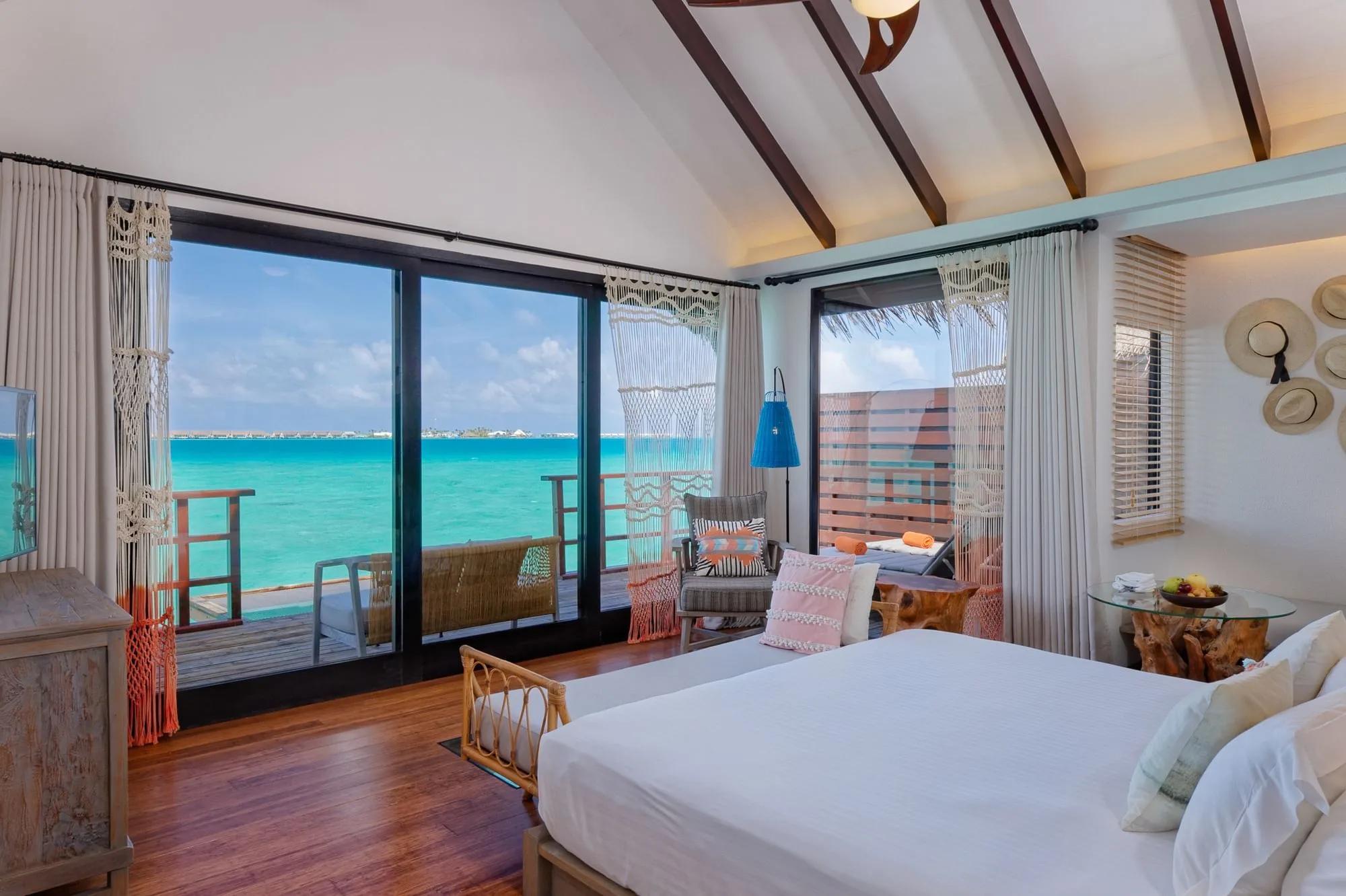 The bedroom of a Lagoon Water Villa overlooking the ocean