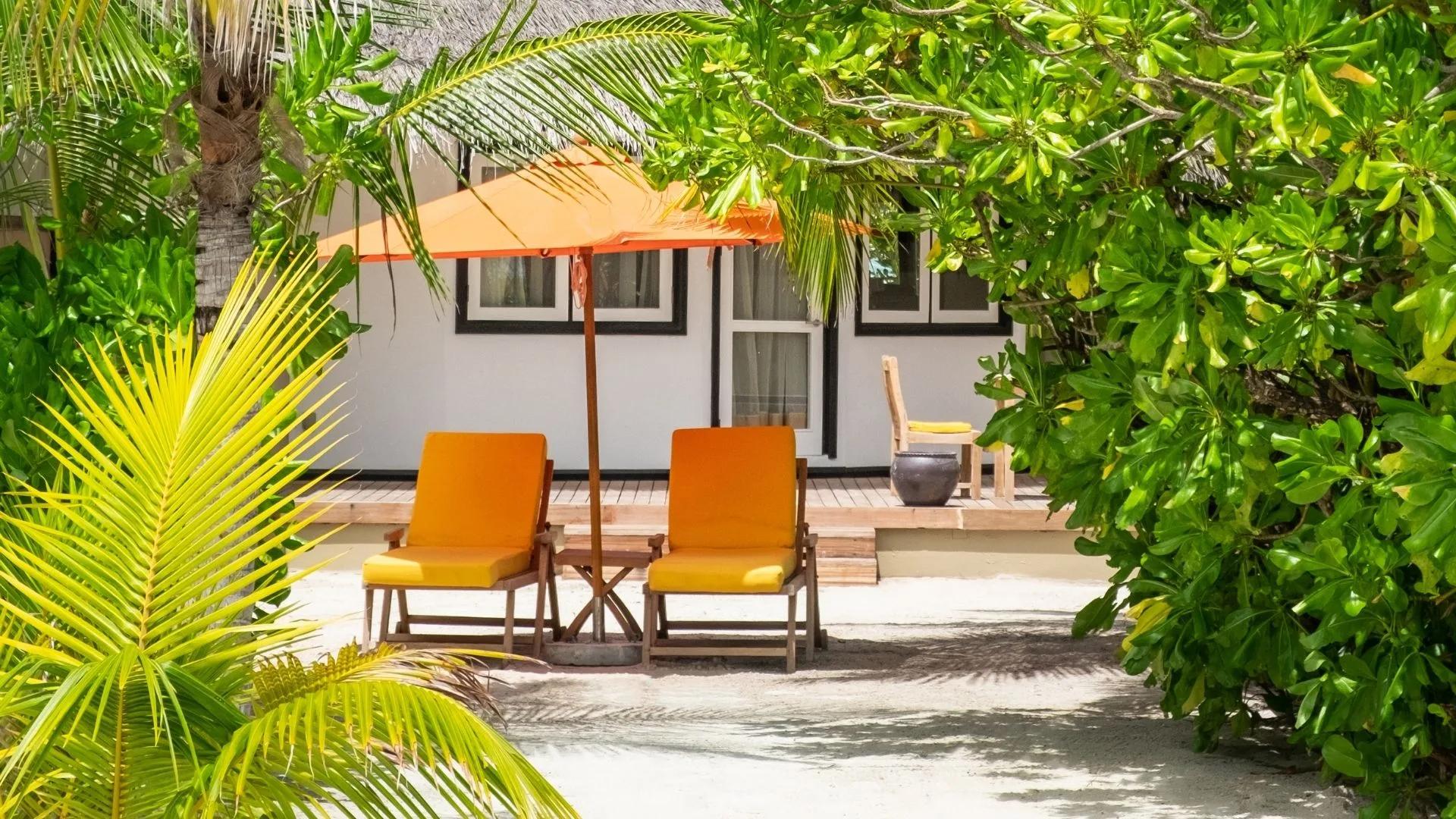 Exterior of a Beachfront Villa at Angsana Velavaru, its cajan-roofed hut set on the beach