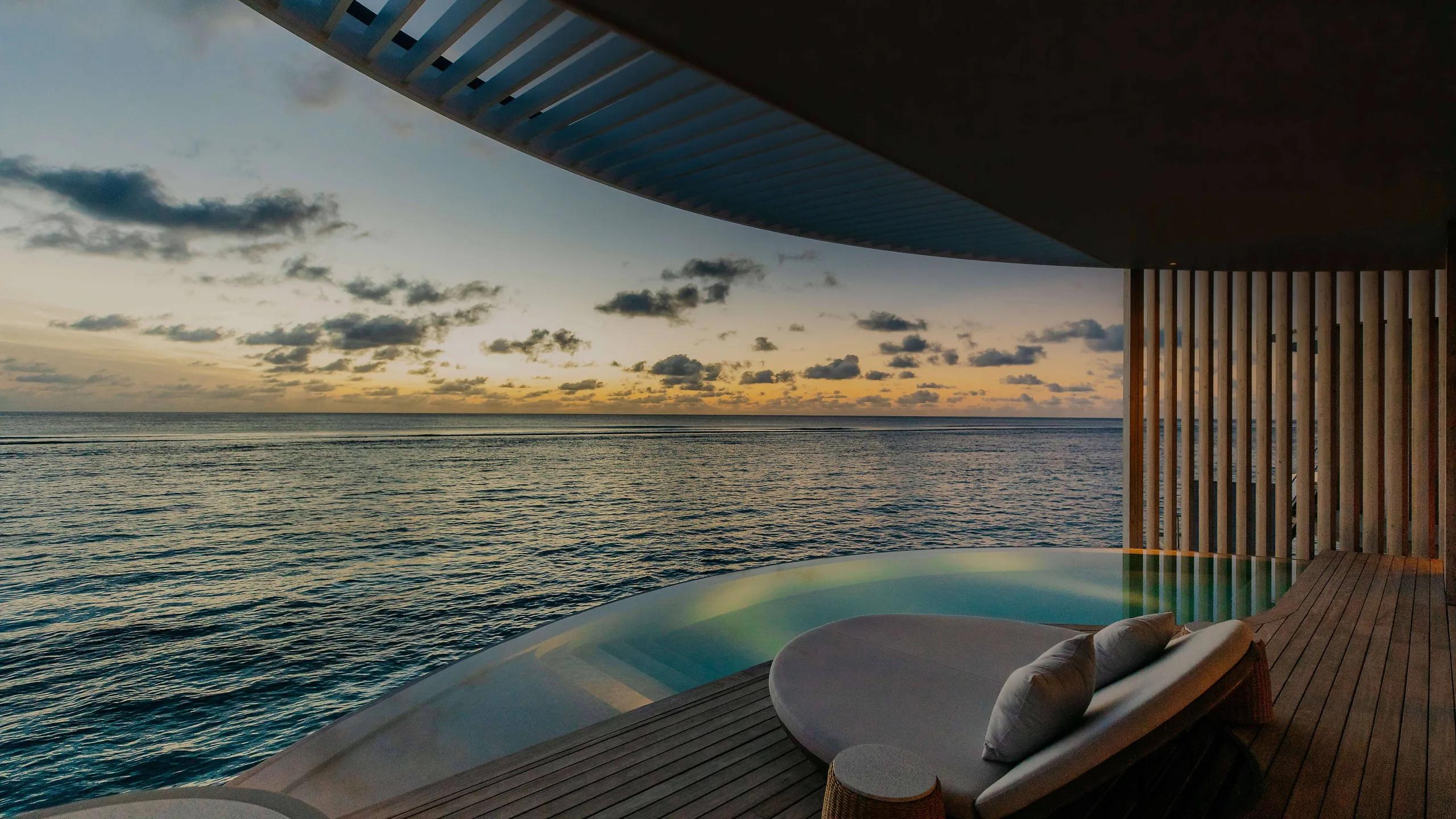 An Ocean Pool Villa's twilight infinity pool and deck — stands in for the Lagoon Pool Villa, which has no dedicated photography on the official site
