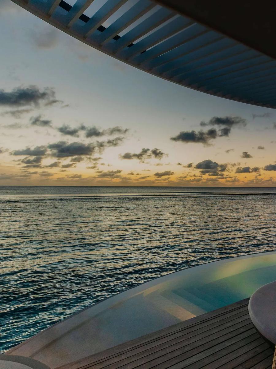 An Ocean Pool Villa's twilight infinity pool and deck — stands in for the Lagoon Pool Villa, which has no dedicated photography on the official site