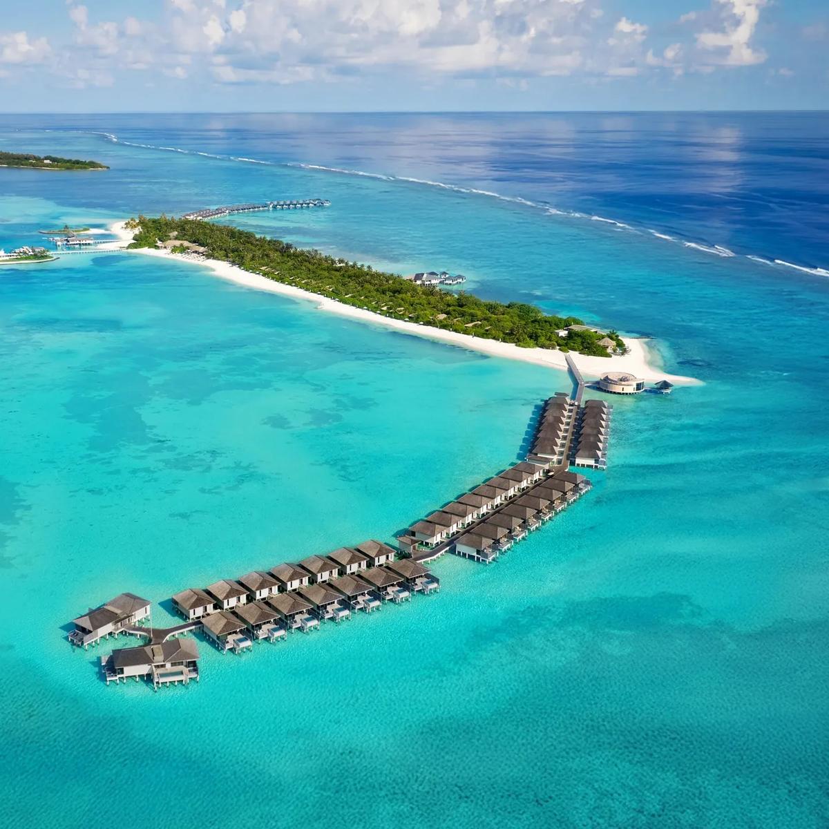 Aerial view of Le Méridien Maldives Resort & Spa's overwater villas fringing Thilamaafushi Island, Lhaviyani Atoll